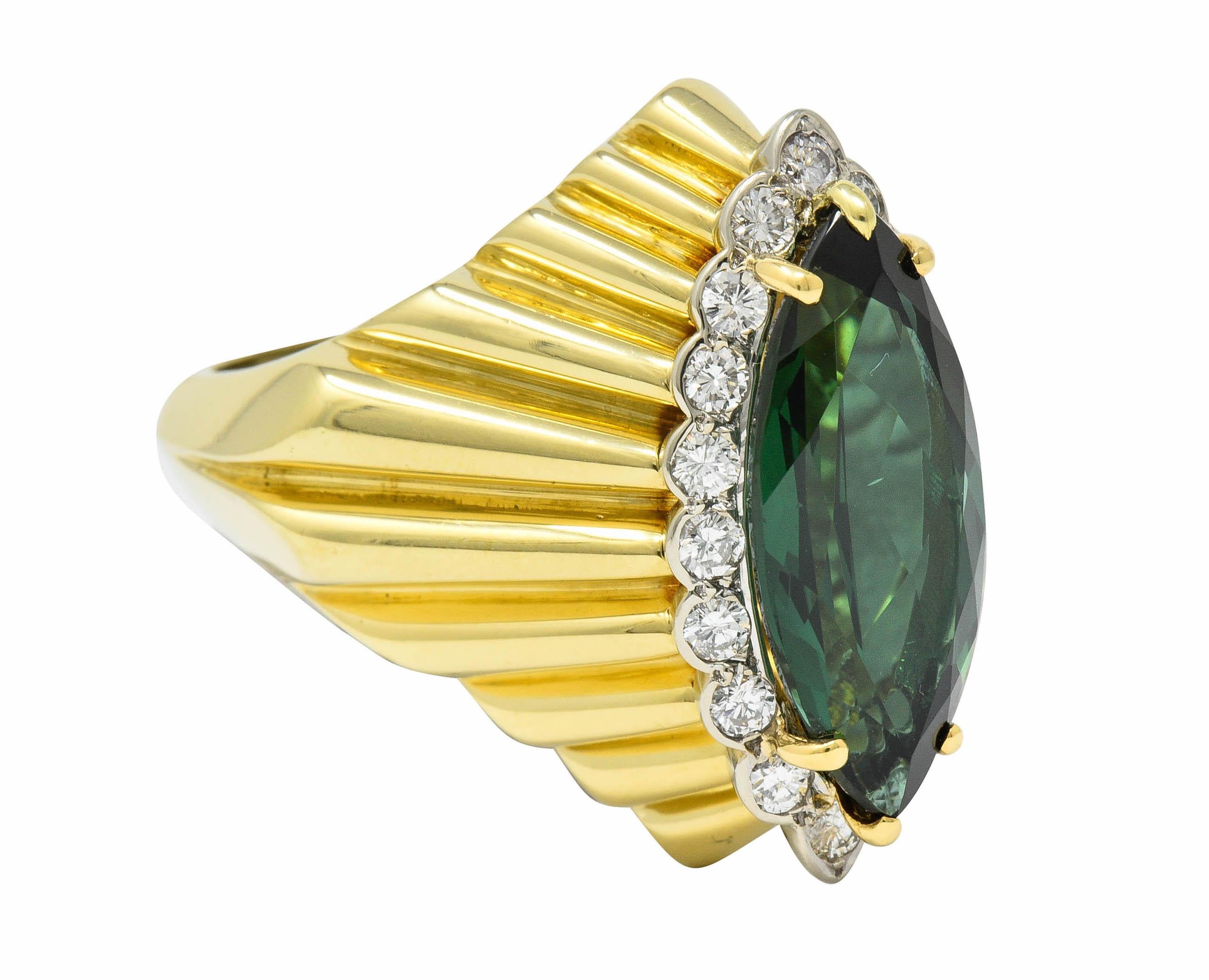 Incredibly dynamic mounting designed as a radiating linear motif

Centering a marquise cut tourmaline weighing approximately 6.70 carats; medium-dark green in color

Surrounded by a halo of round brilliant cut diamonds weighing in total