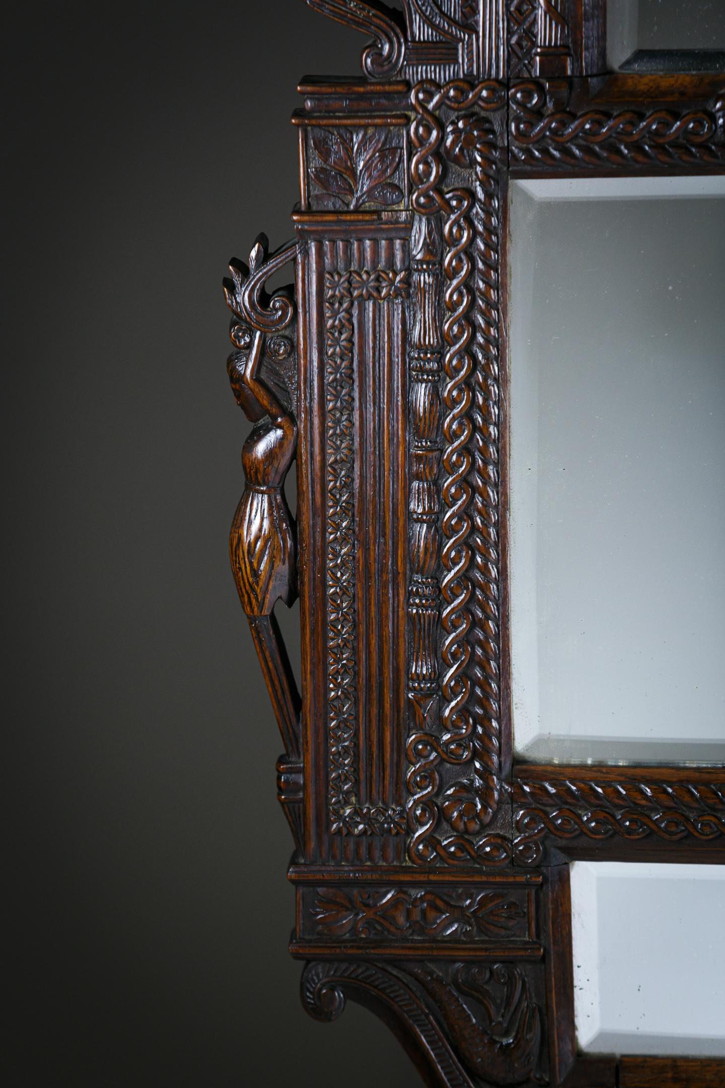 Extraordinary Carved Wood Mirror, Hugely intricate with Faces, hippocampi and figures to each side amongst a sophisticated geometric Tour de force of Carving. France circa 1880.