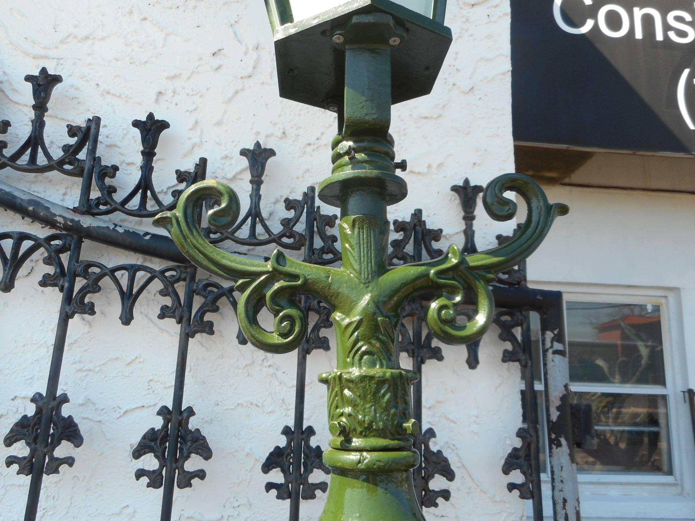 This extremely tall cast iron street lamp features one lantern on the top and a scroll design underneath. This amazing floor lamp has long iron pole with etched detail throughout. The perfect addition to any residential or commercial setting. Please