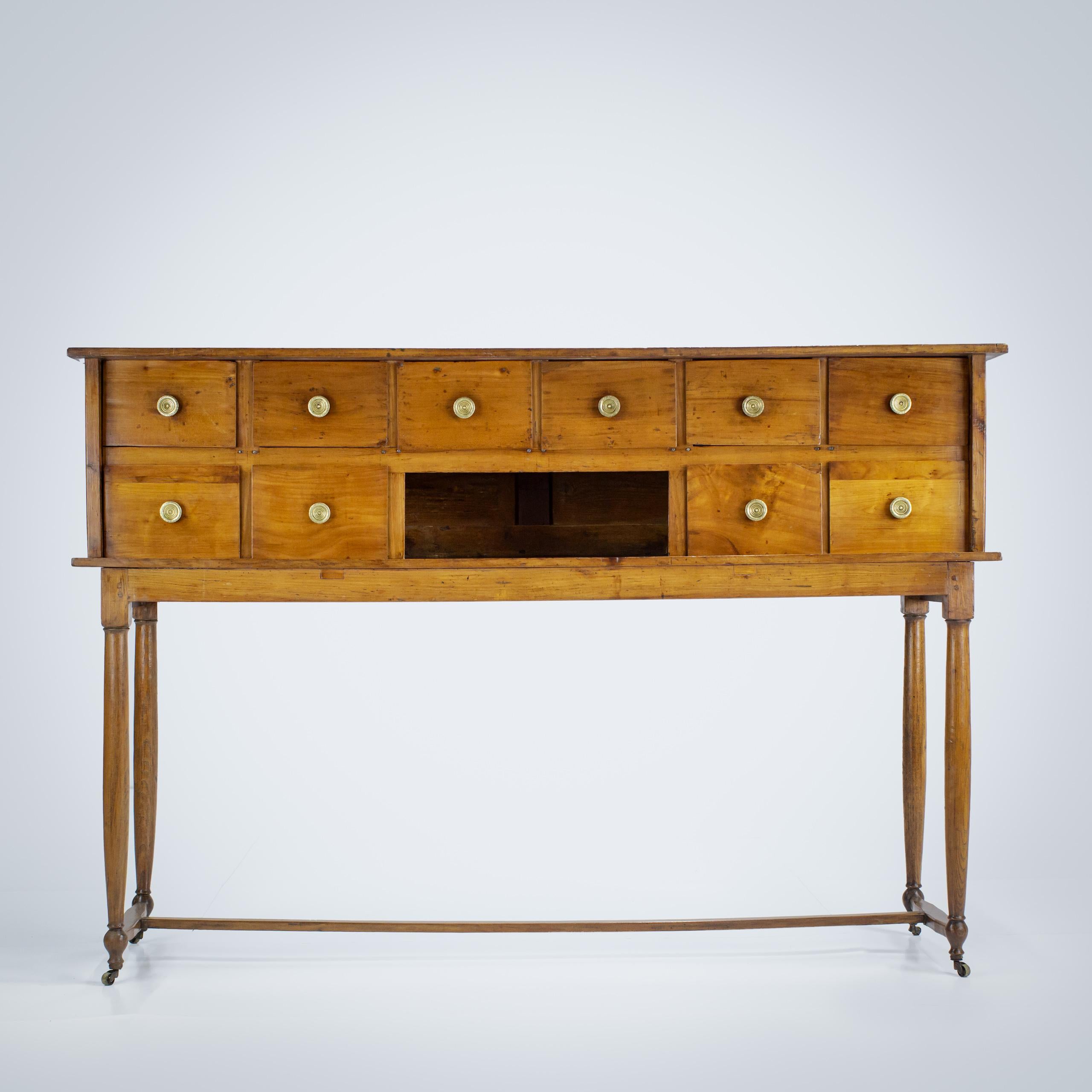 Early 19th Century Provincial Console with 10 Drawers. Beautifully delicate legs and stretcher, standing on castors, eminently useful hallway console. Cherrywood France Circa 1820.