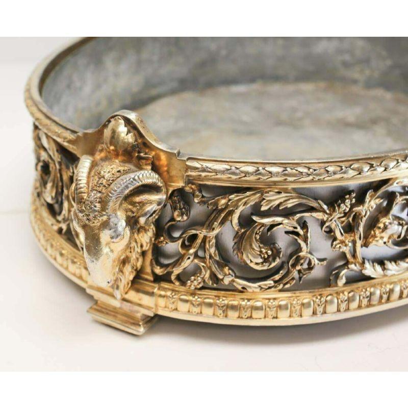 Impressive Christofle gilt silver plate centerpiece planter or jardinere, 19th C

A large and impressive gilt silvered bronze planter or jardiniere by Christofle, with open work depicting fruiting vines, the handles realistically modeled as rams