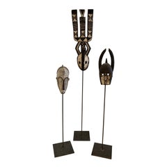 Impressive Collection of African Carved Wood Masks on Tall Custom Iron Stands