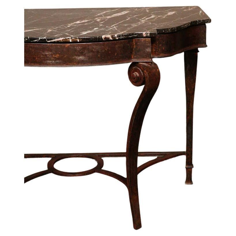 Impressive console, attributed to Raymond Subes, made of solid wrought iron with natural brownish oxidized patina and marble top.
