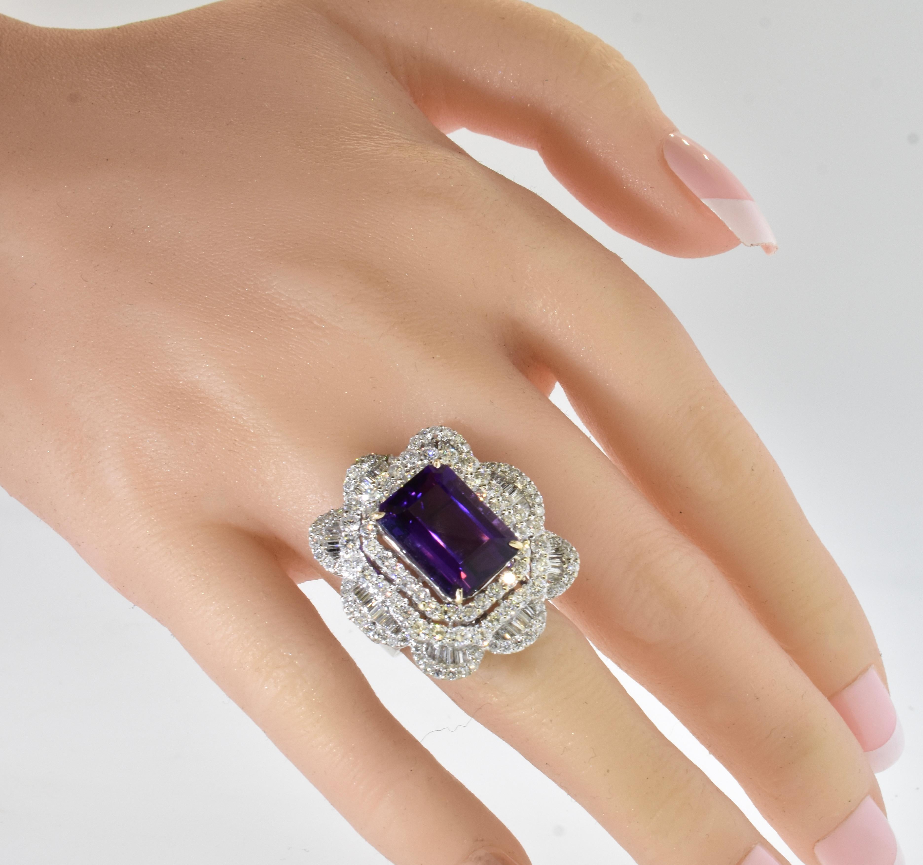 Amethyst and Diamond Large and Important 18K White Gold Ring.
This is a large, 1.25 inches vertically, by 1 - 1/8th inch ring that possesses a complex white on white design and that centers a 9.5 ct. emerald cut gem amethyst of vivid purple color.
