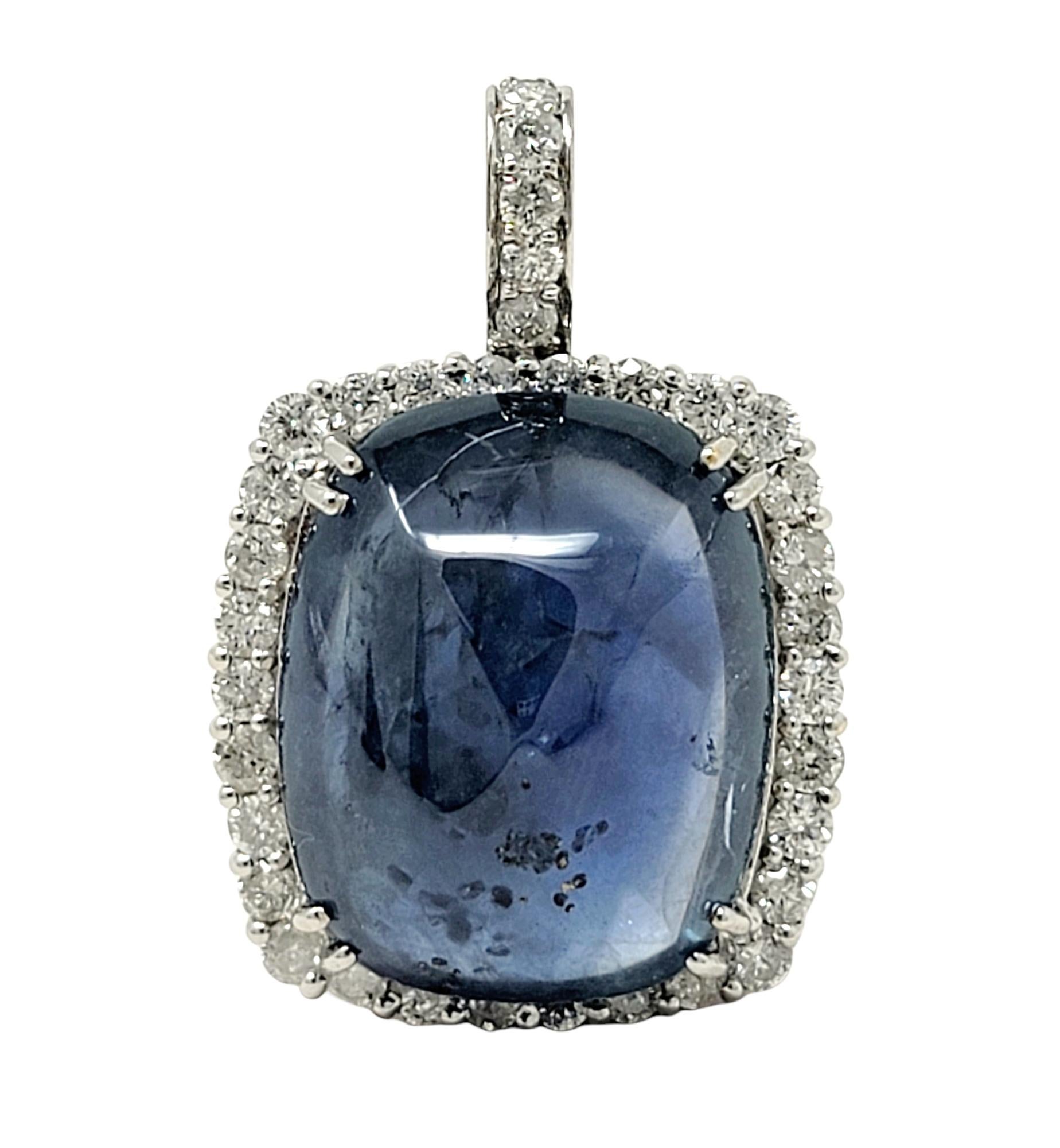 This stunning, sizeable sapphire and diamond pendant will take your breath away! This exquisite natural sapphire from Burma (Myanmar) is an impressive 48.83 carats, cushion shaped, cabochon cut, with an incredible transparent blue color with no