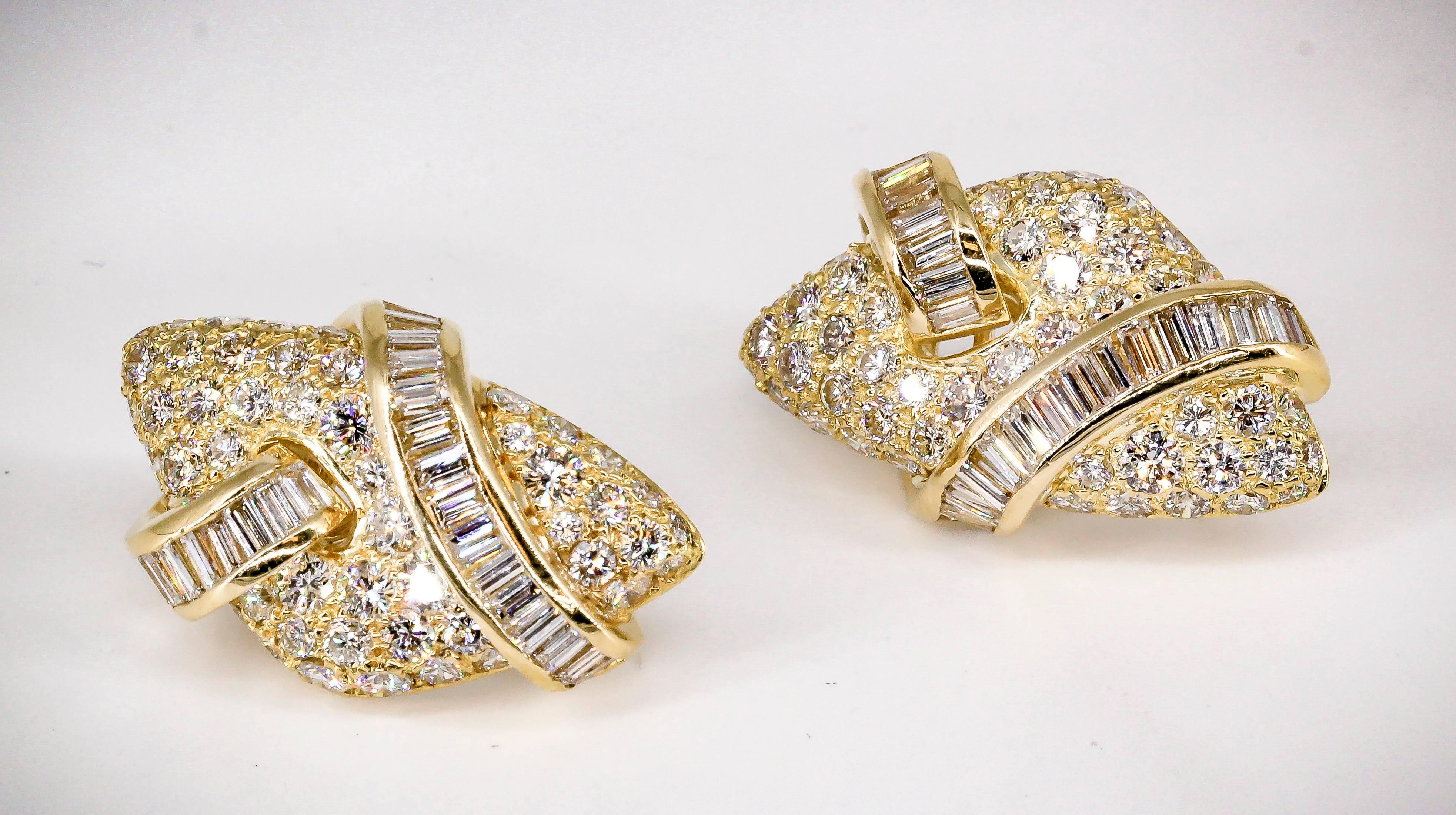 Chic diamond and 18K yellow gold earrings. They feature high grade round and baguette cut diamonds throughout, approx. 7-8 carats total weight. Creative design with the string of baguette cut diamonds going around and through the larger