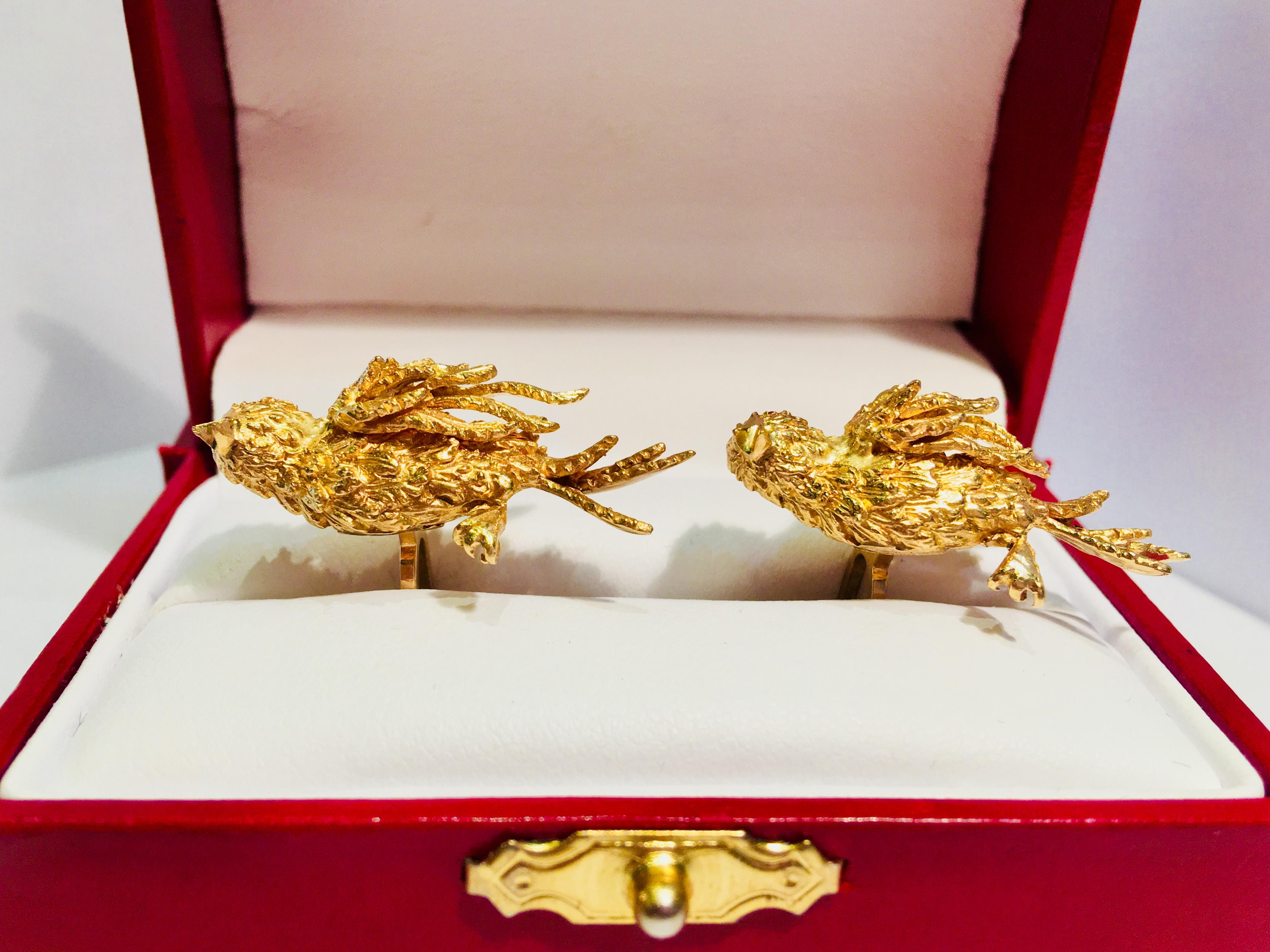 Distinctive, vintage, mid-century, hand-made 14 karat yellow gold estate cuff links feature richly textured, incredibly detailed, sculptural, standing eagle birds in profile with pave set, round ruby eyes, an open beak, a clawed foot and flowing,