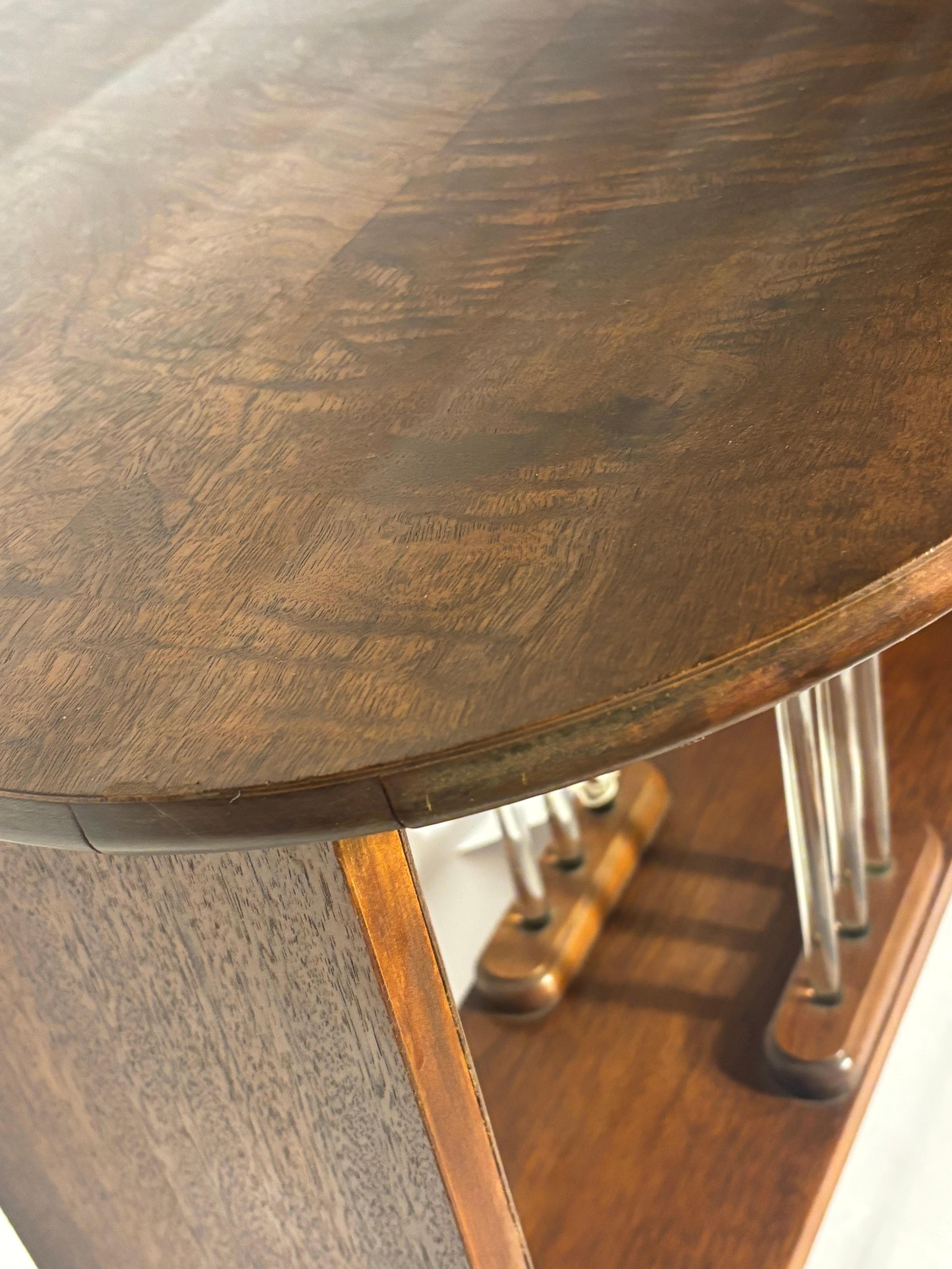 A very handsome Art Deco side table with oval top resting on striking central focus of glass rods.  
