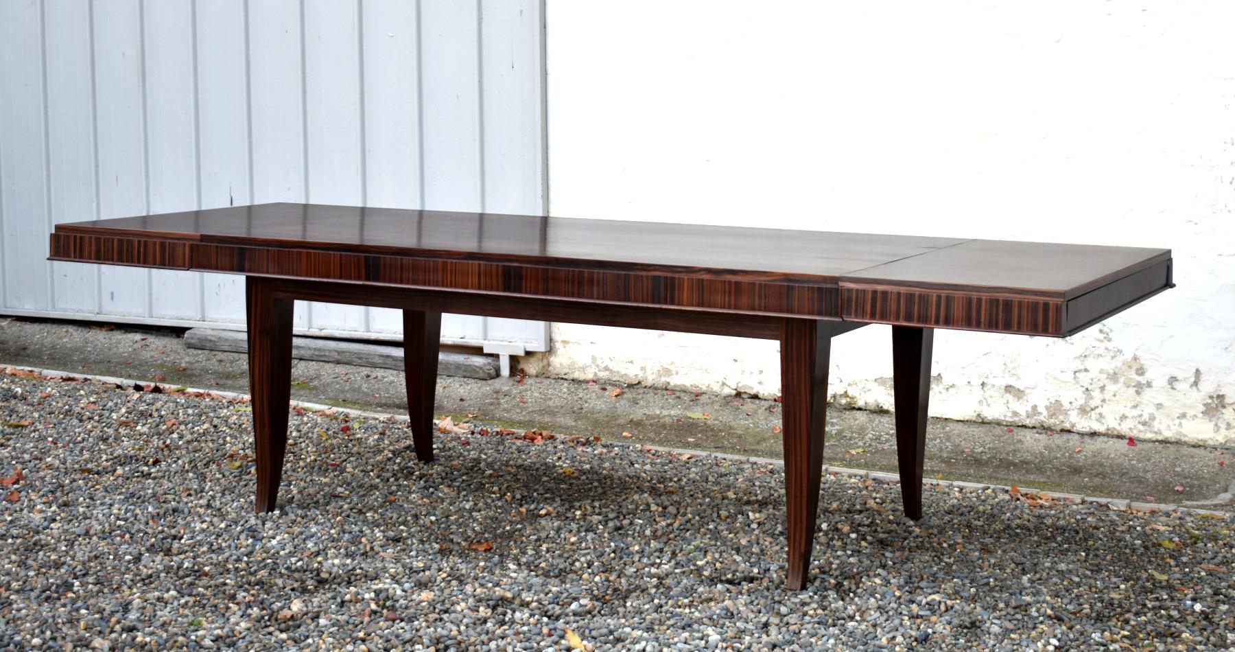 Impressive French Macassar Ebony Dining Table Art Deco Style 

This large impressive extendable dining table in macassar ebony opens out with the addition of two drop-in leaves, enabling comfortable seating for up to 12 people. 

The table is of