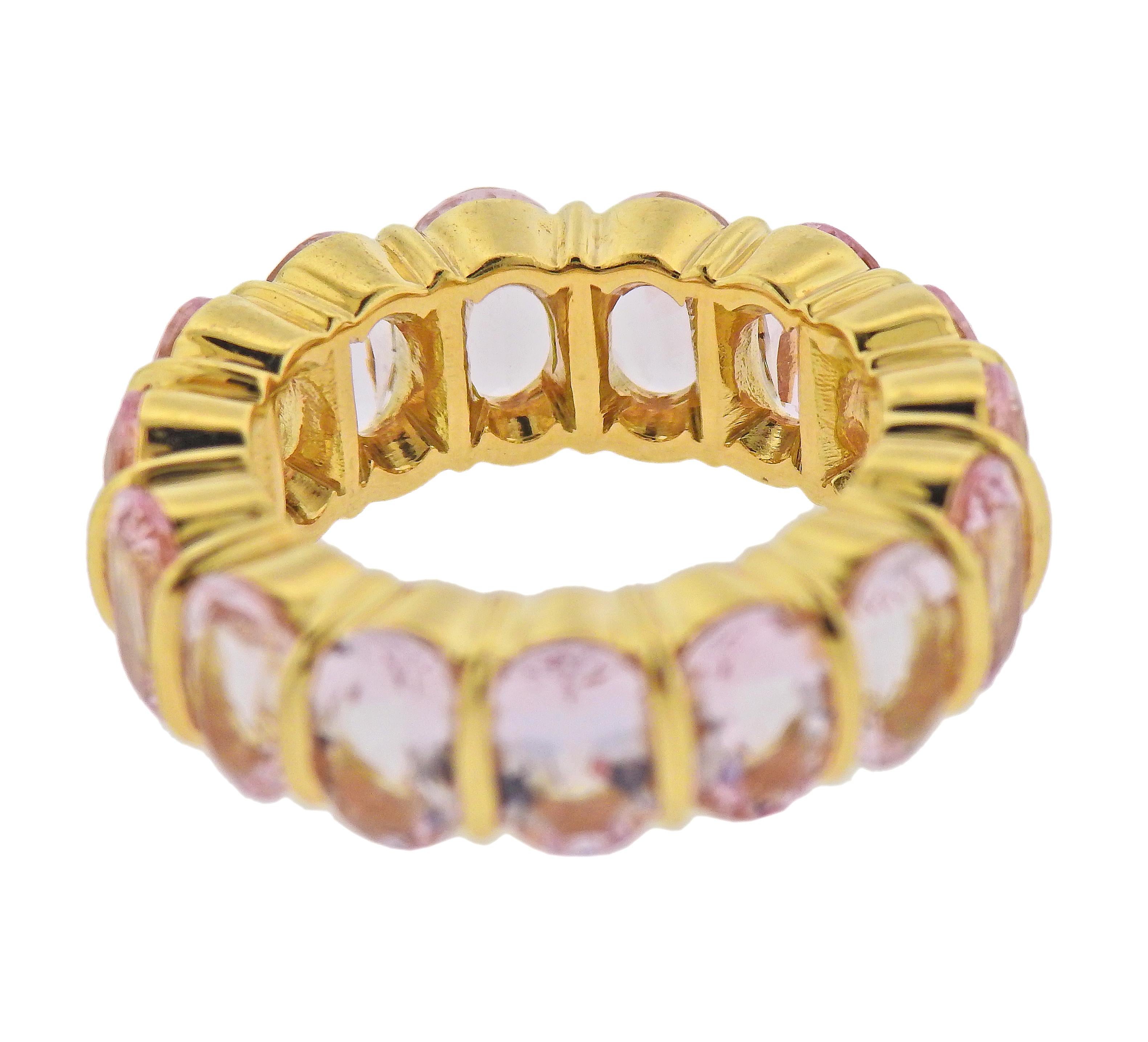 18k gold wedding band ring by Gemlok, set with a full circle of oval kunzite gemstones , measuring approx. 7 x 4.8mm. Ring size - 7, ring is 7mm wide. Marked: 750, Gemlok. Weight - 14.1 grams. 