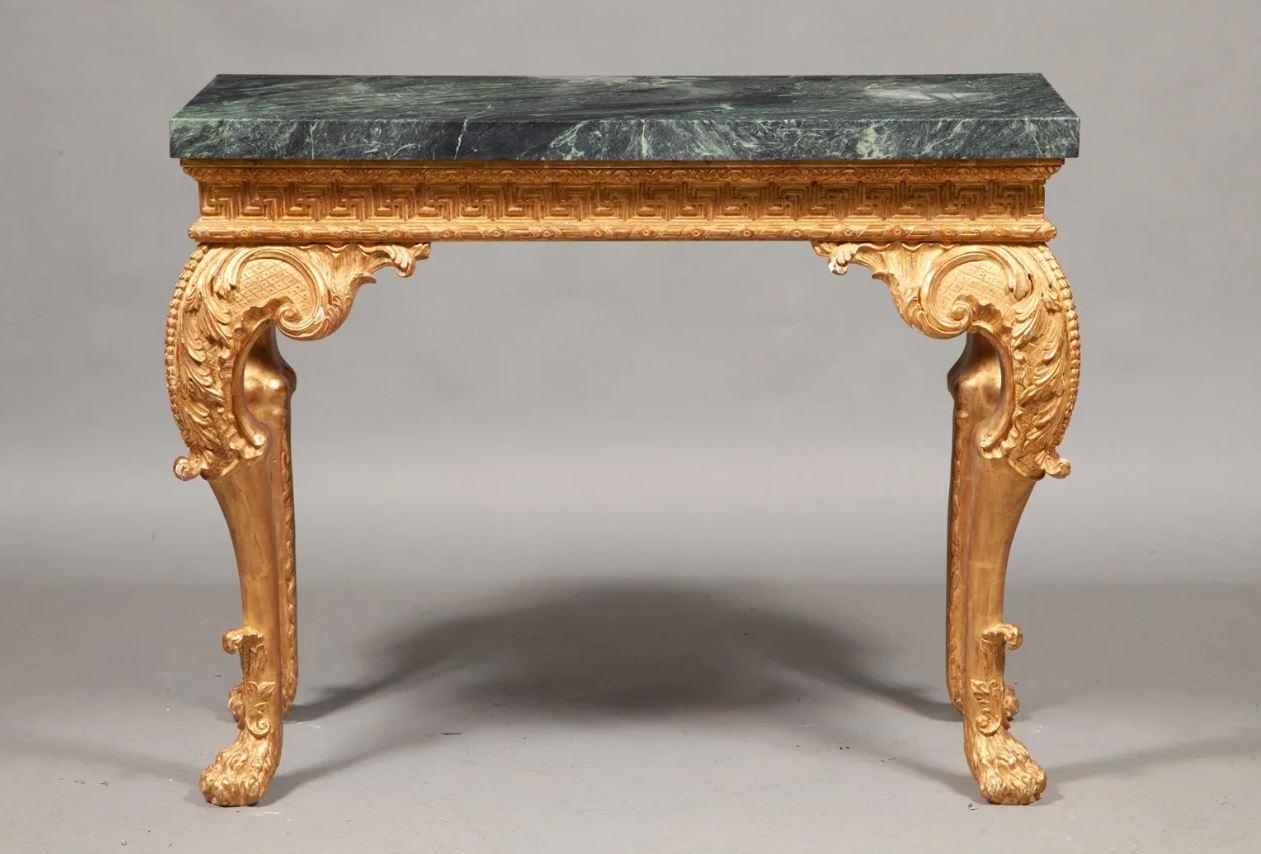 Impressive giltwood console table with ornate base in George II style with Greek key motif to apron and black and green marble top.