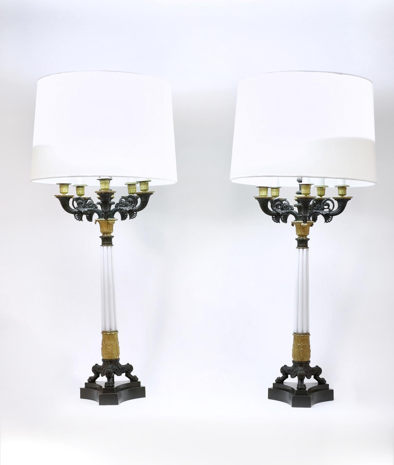 Impressive pair of gilt bronze with art glass column candelabras table lamps. Each lamp is in great working vintage condition. Minor wear consistent with age / use. Each lamp stand about 38 inches high. Each drum shade is 11