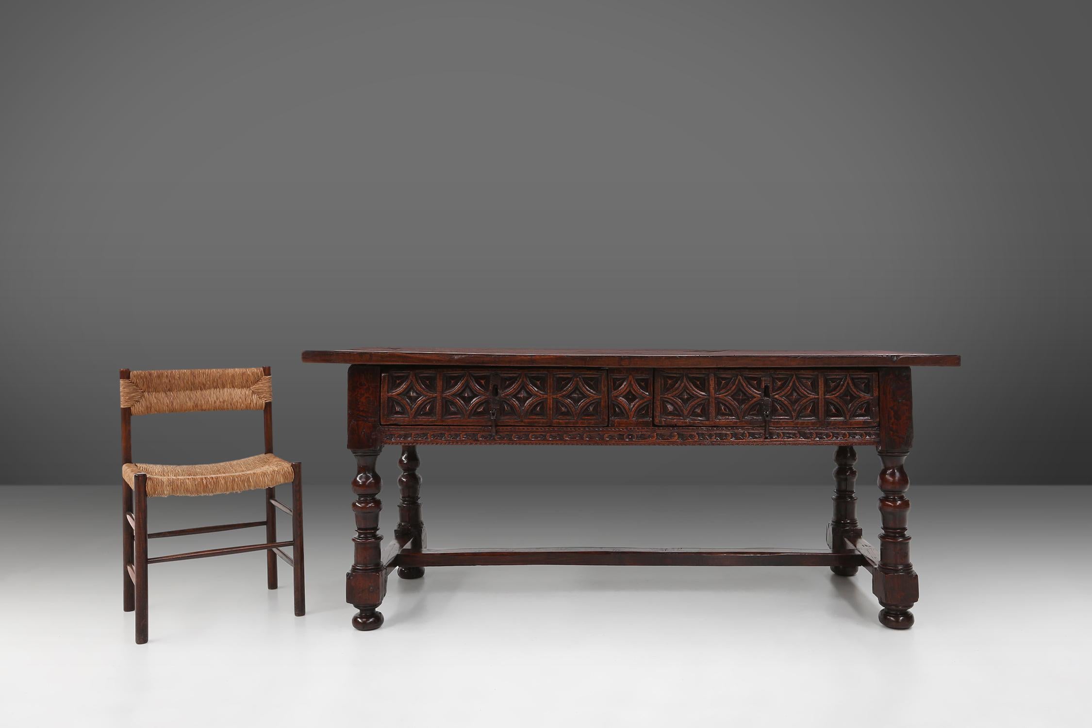 Spain / 1550 / console table / oak / rustic / antique / wabi sabi 

A Spanish console table with geometric carvings and two drawers, made around 1550. Decorated with a two-drawer frieze with carved geometric motifs and drop pull handles. Finished on