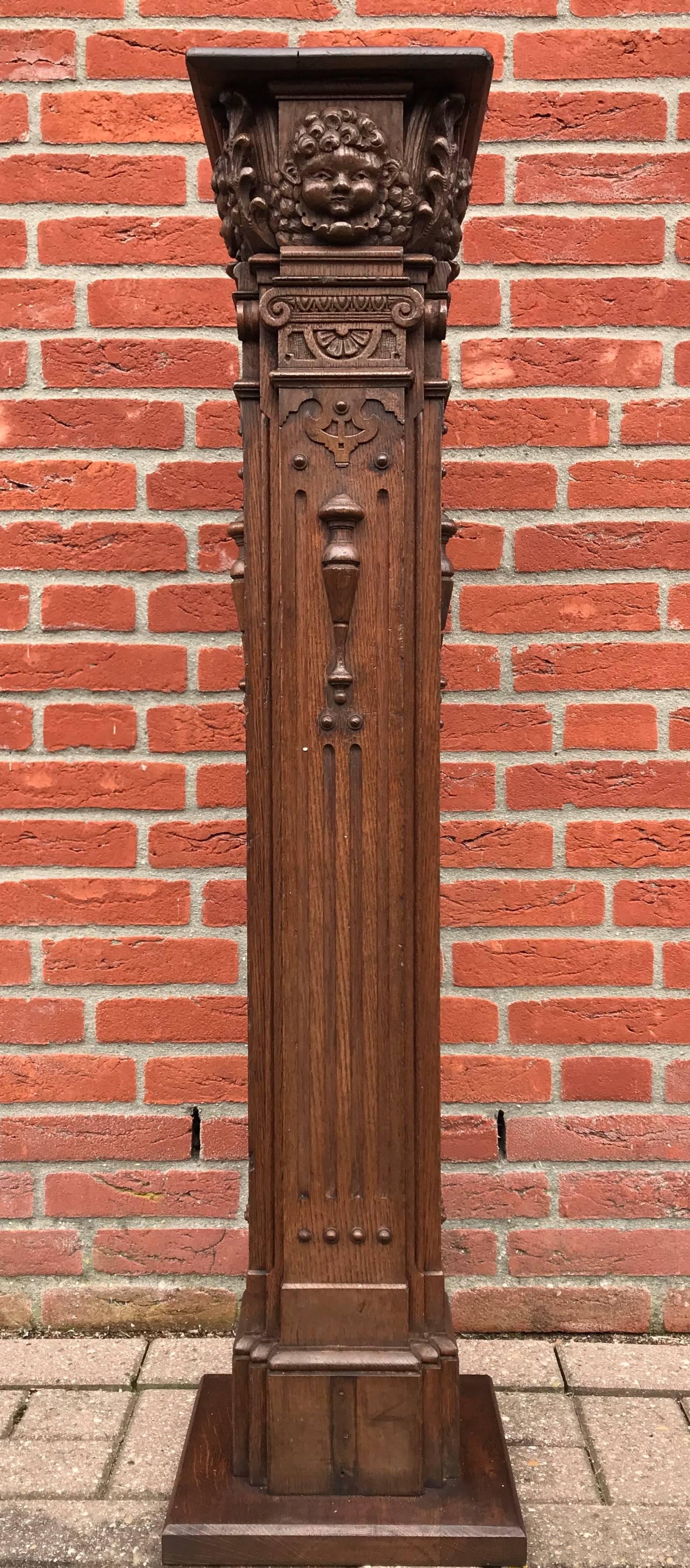 Rare and great quality carved, Renaissance Revival stand with cherub masks.

This unique pedestal originally was a newel post and it is beautifully and richly carved all around. This Fine work of craftsmanship would have graced the start of the