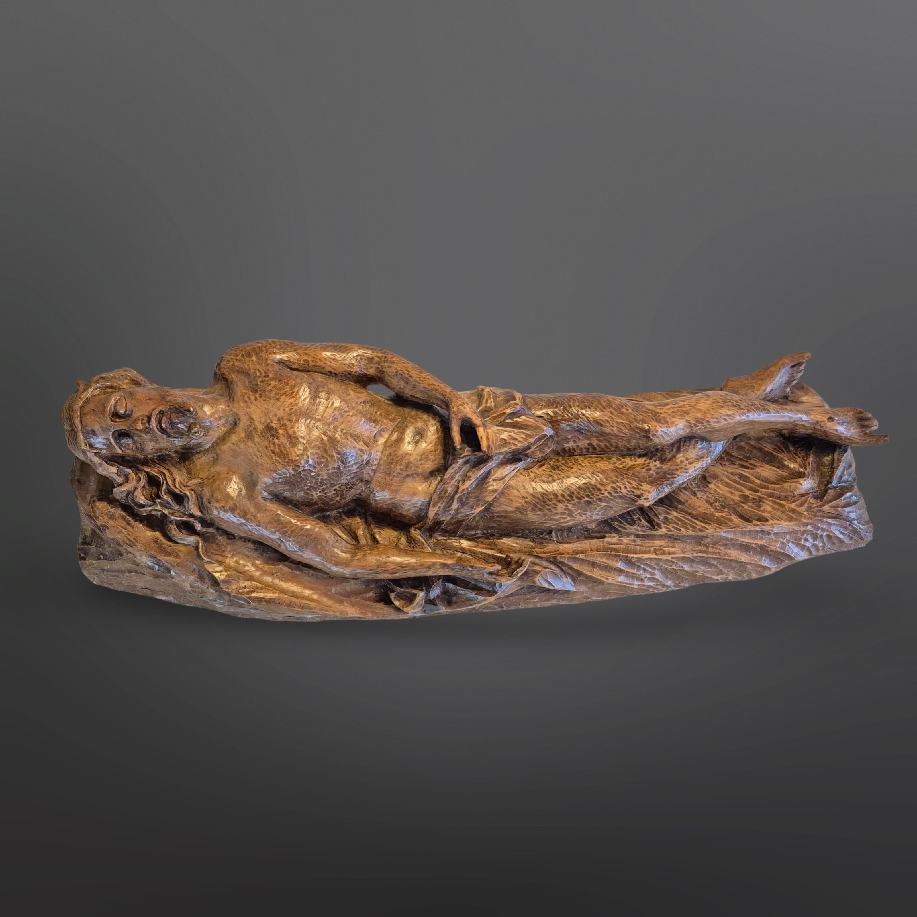 Impressionnante statue sculptée à la main d'un Christ couché. Sculptée dans une pièce de chêne massif. Une taille impressionnante. 
L'anatomie est correcte et l'expression du visage est étonnante. Réalisé par un artiste habile et