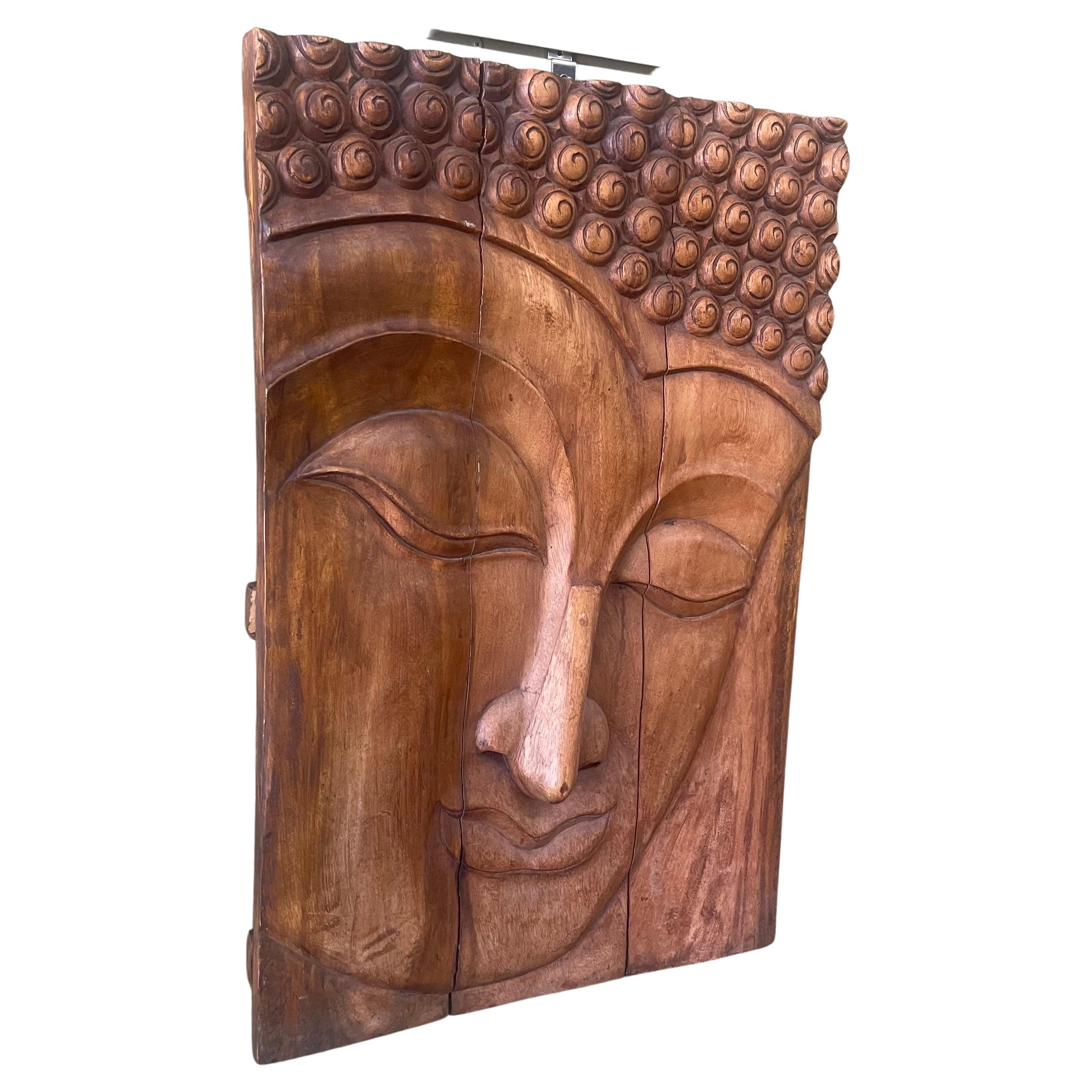 A very cool and impressive hand-carved teak young Buddha wall hanging from Thailand, circa 1980s. The piece is in very good vintage condition and measures 23.5