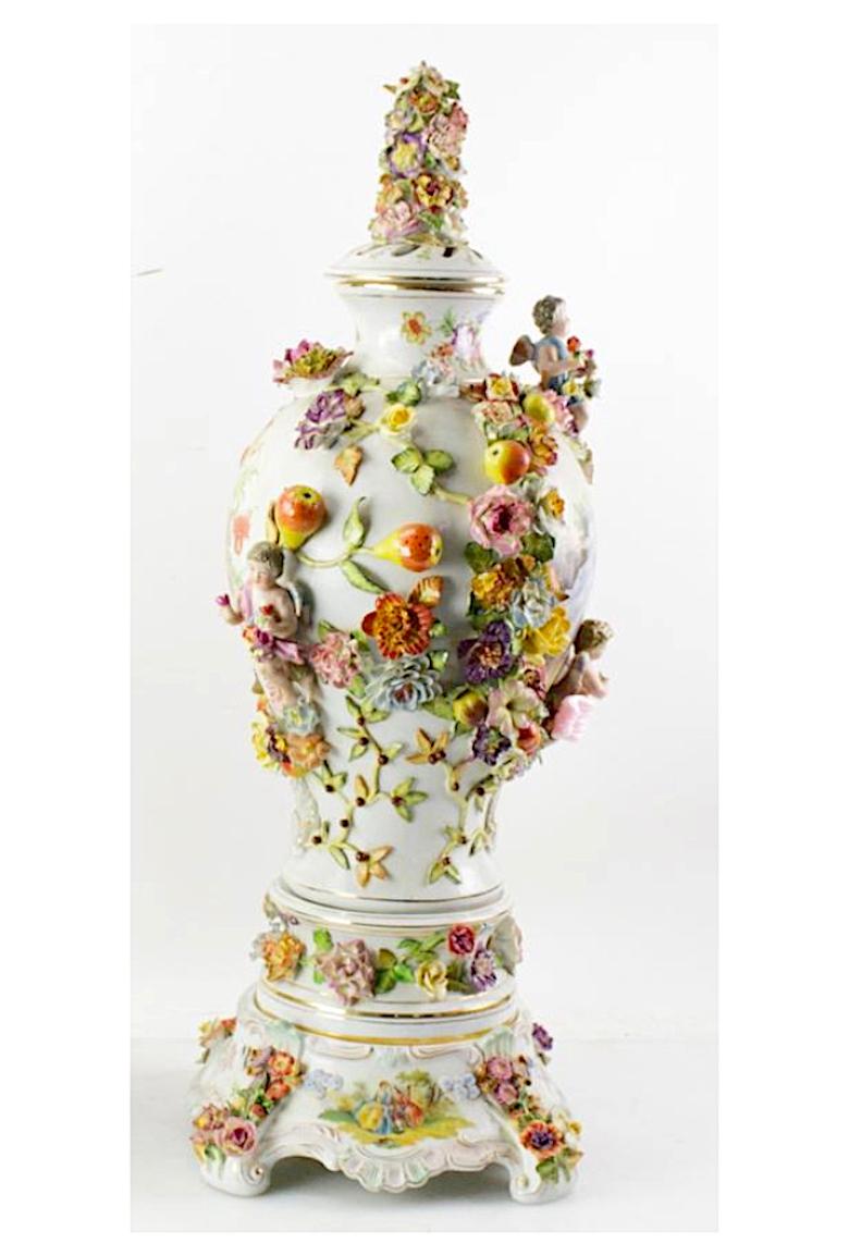 Elevate your home decor with this exquisite three-part German Dresden Porcelain Decorative Covered Urn, a masterpiece of artistic craftsmanship and timeless beauty. This stunning urn is a work of art, delicately hand-painted with intricate floral