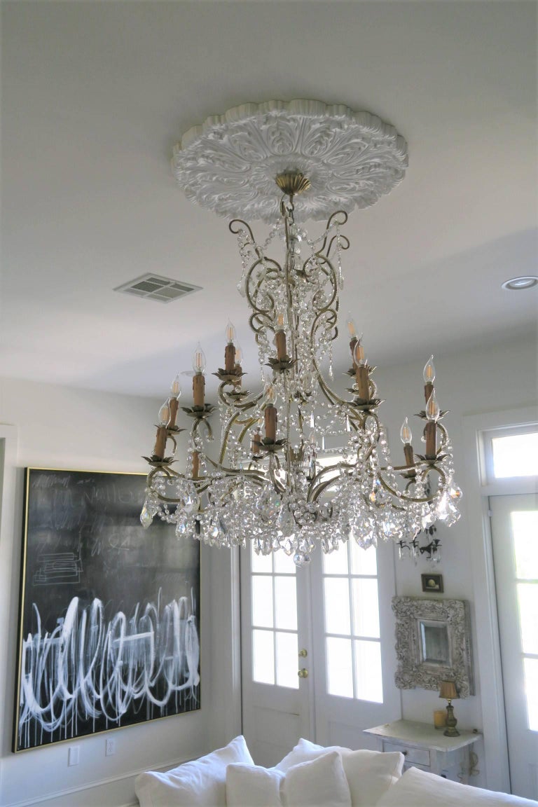 Absolutely decadent Italian custom made crystal chandelier handcrafted in Italy with hundreds of Murano glass crystals of sizable weight. Crystals are individually hand knotted and tied and crystal beading are wrapped around each of the antiqued