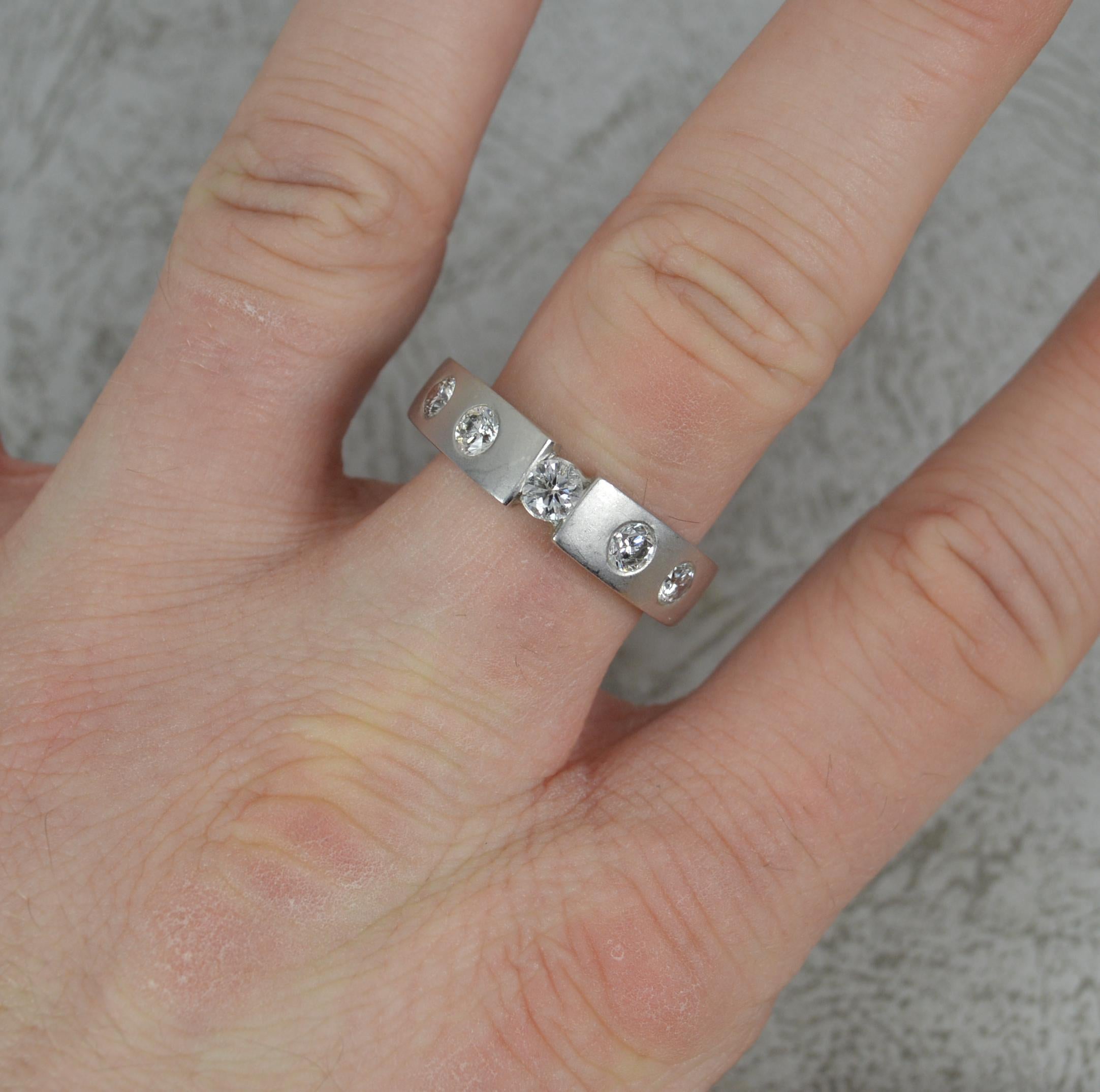 A rather impressive 18ct Gold and Diamond ring.
Solid and heavy 18 carat white gold example with a matte, non polished finish. (Can be polished to make shiny).
Set with a larger round brilliant cut diamond to centre in tension setting with a further