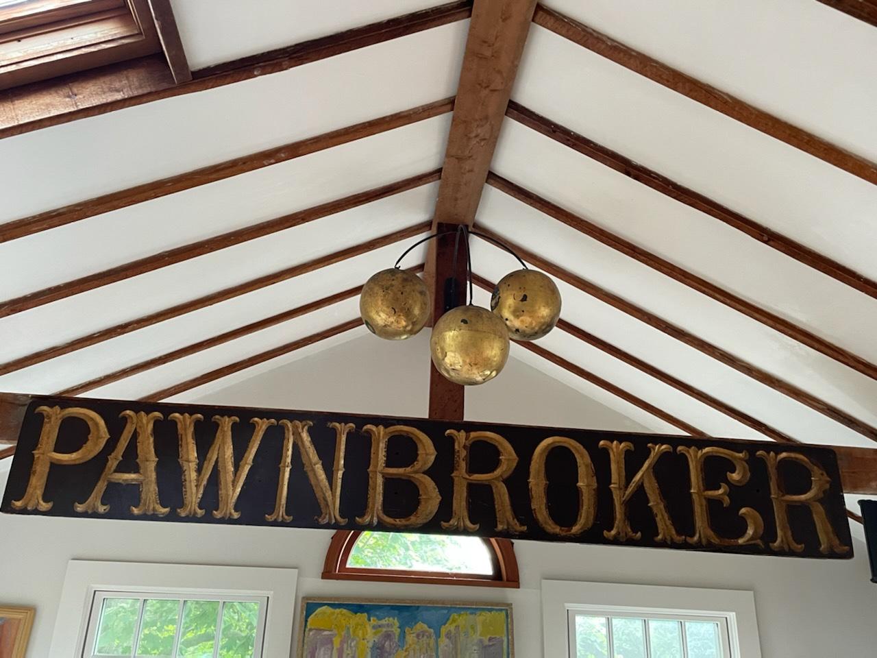 An impressive rare and monumental in scale folk art pawnbroker trade sign with accompanying trio of giltwood spheres which represent the universal symbol for the pawnbroker trade.  Spheres are suspended by a wrought iron backplate 8.5 