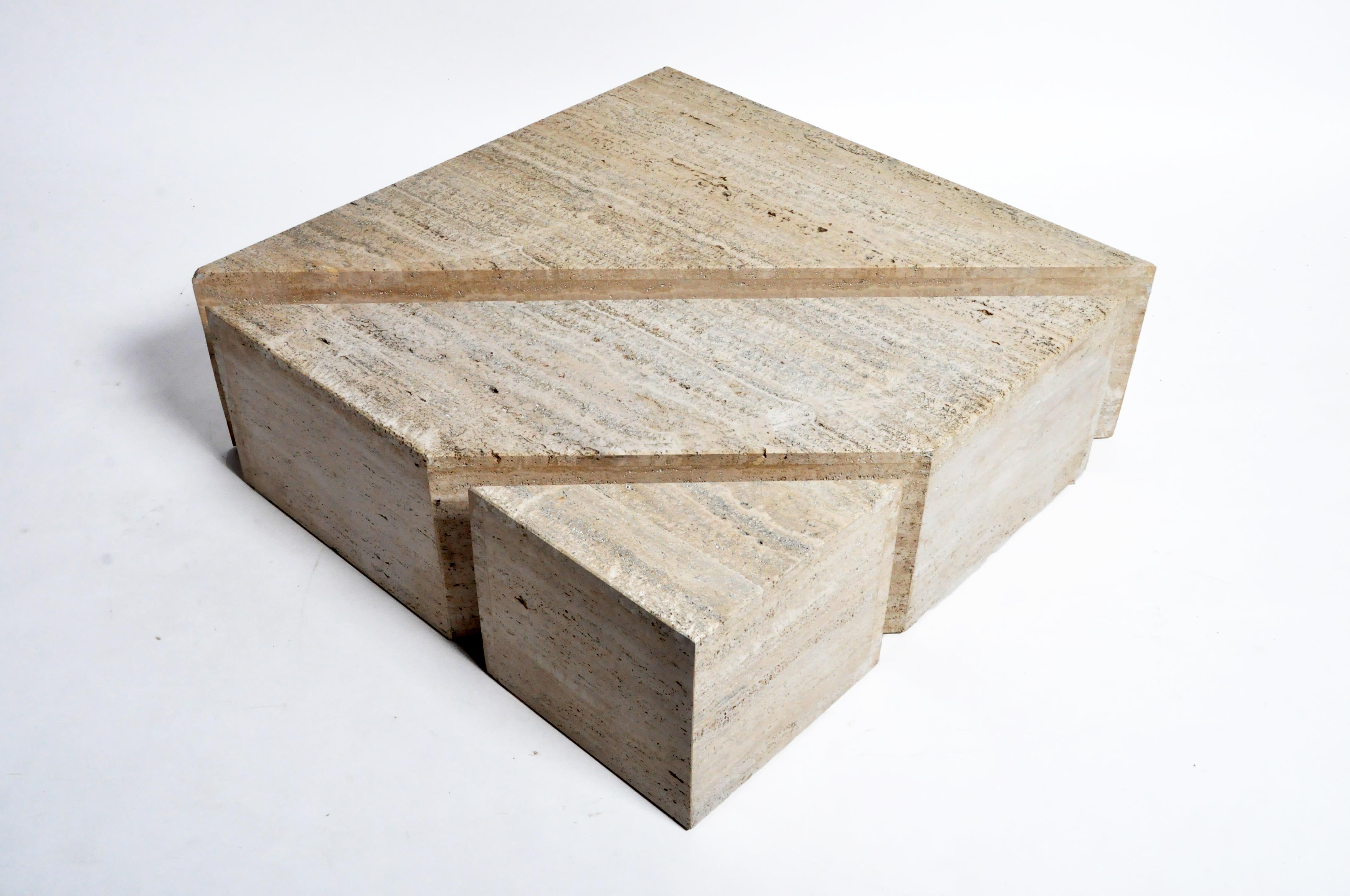 This impressive coffee table split into three polygonal sections that can be configured into a wide variety of interior arrangements. This table is from Italy and was made from travertine marble, circa 1970.