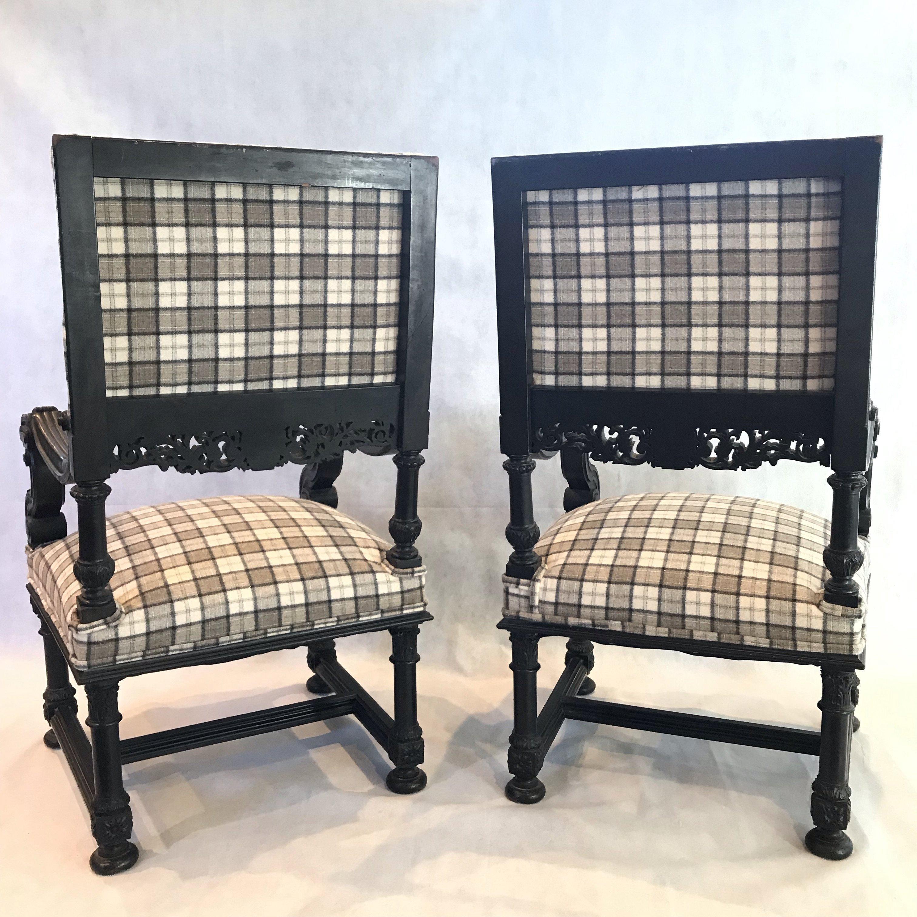 Beautiful period pair of French intricately carved ebonized lion's head armchairs newly upholstered in welsh plaid flannel. Meticulous carving on arms and back apron.
#77.
     
