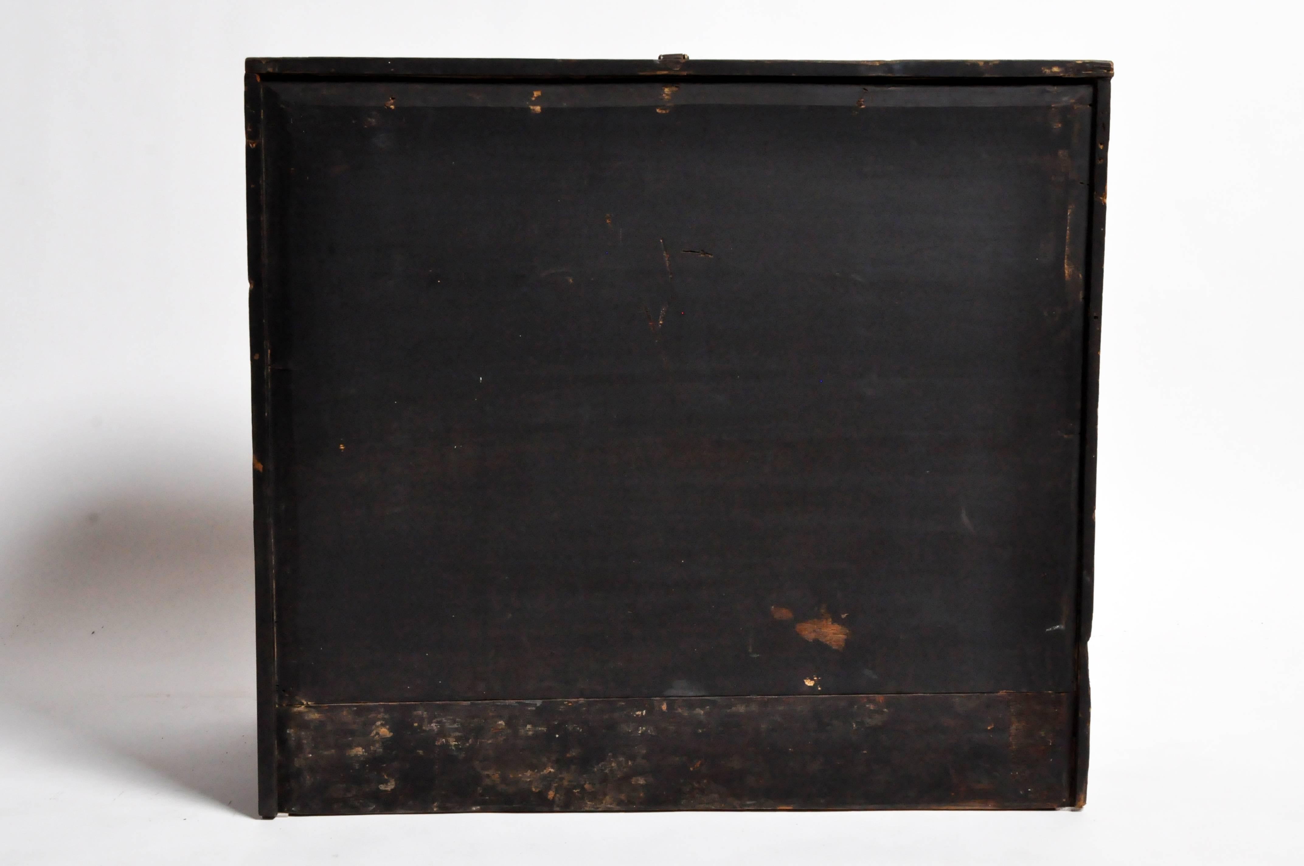 This softwood storage trunk has highly stylized decorative iron fittings, and was used to hold blankets, garments and other gifts that would be presented to the newlyweds as part of the dowry. It has a fall-front opening and large metal handles for