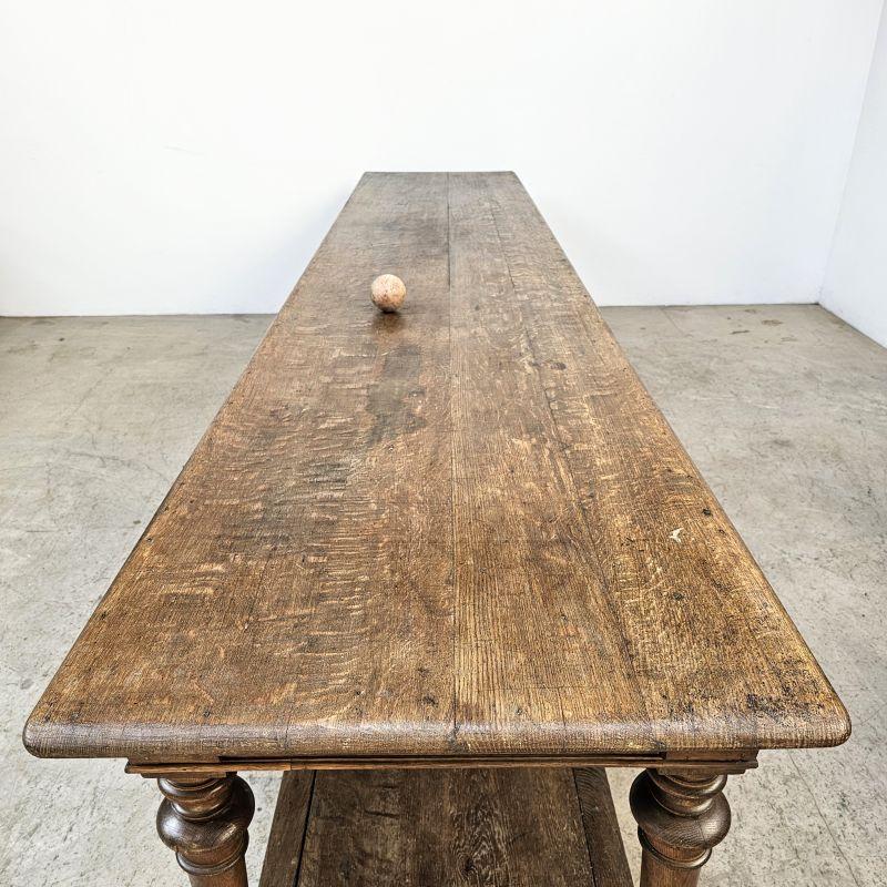 A very impressive and quality large oak drapers table from France. It has 2 drawers on one side for storage and a beautiful colour to the wood giving it a great look. Impressive large turned legs. In very good solid condition ready to use.

Please
