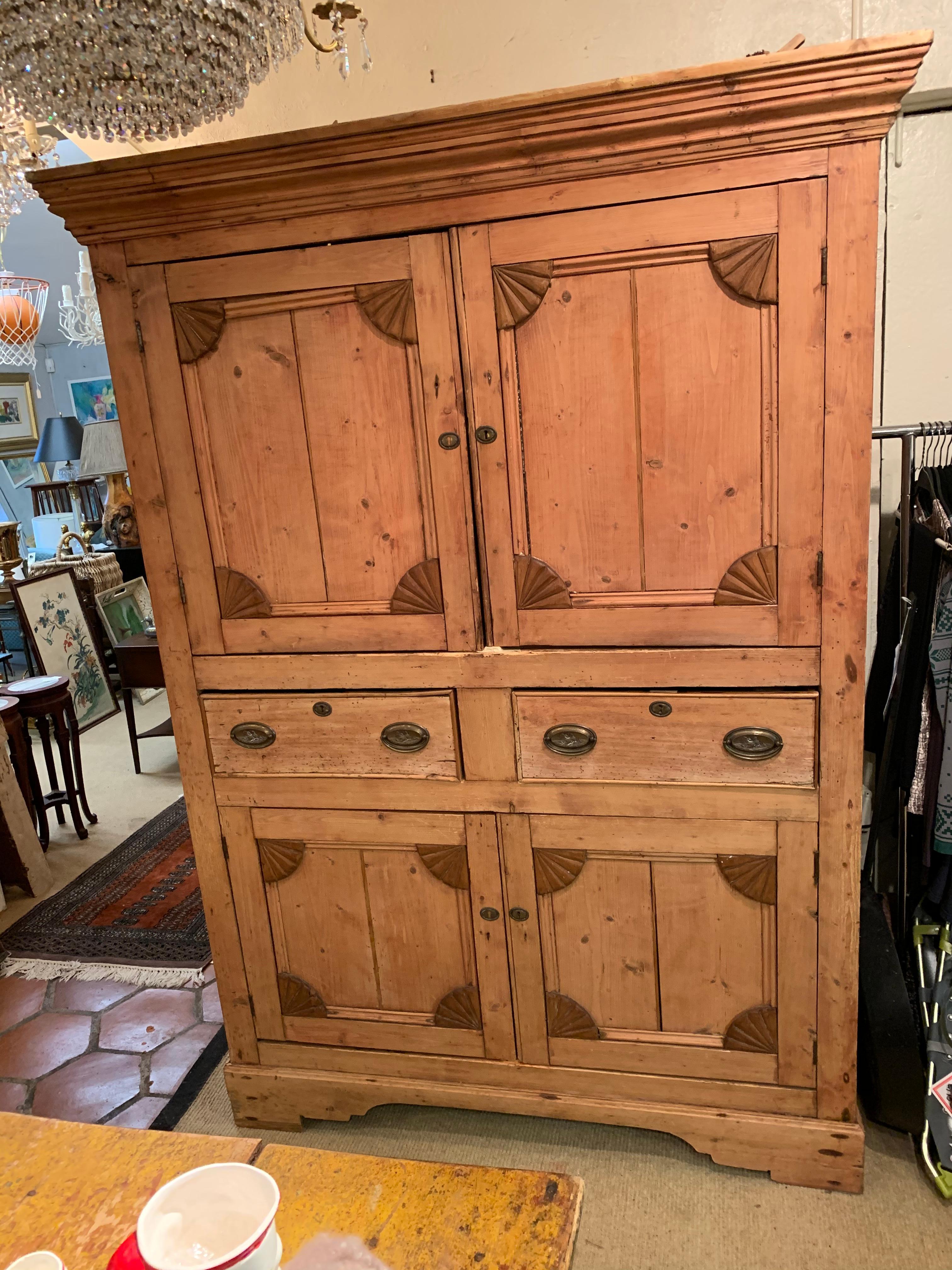 A very large natural rustic Irish pine cabinet hutch with paneled doors top and bottom separated by two drawers. Tons of storage and Americana charm.
Measures: Body is 51 W, 24 D
Shelf in top is 17