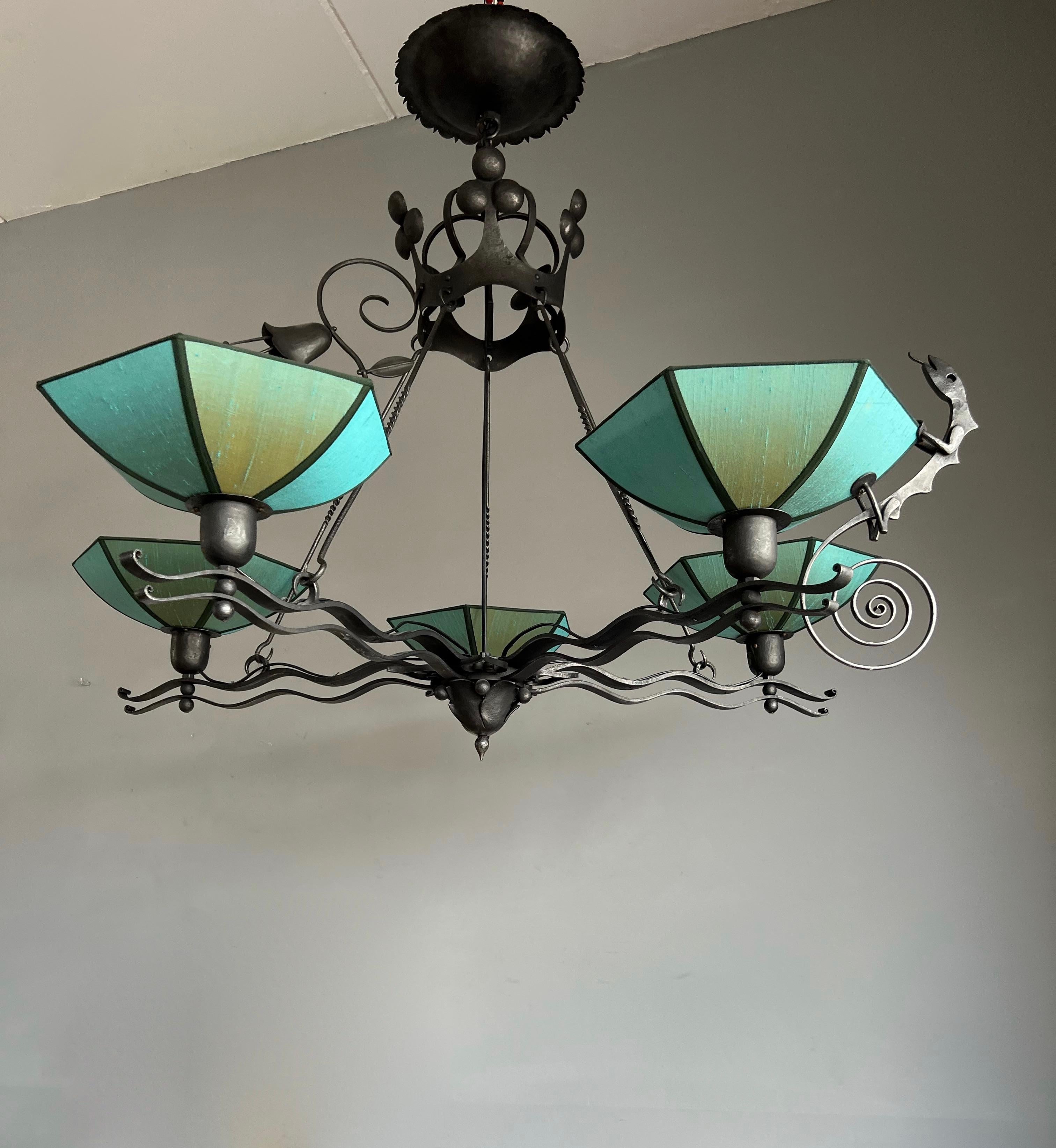 Amazing and skillfully handmade, wrought iron Art pendant.

This artistically designed and outstandingly executed wrought iron chandelier is in excellent condition and it comes with a mint and stunningly stylized salamander sculpture and an equally