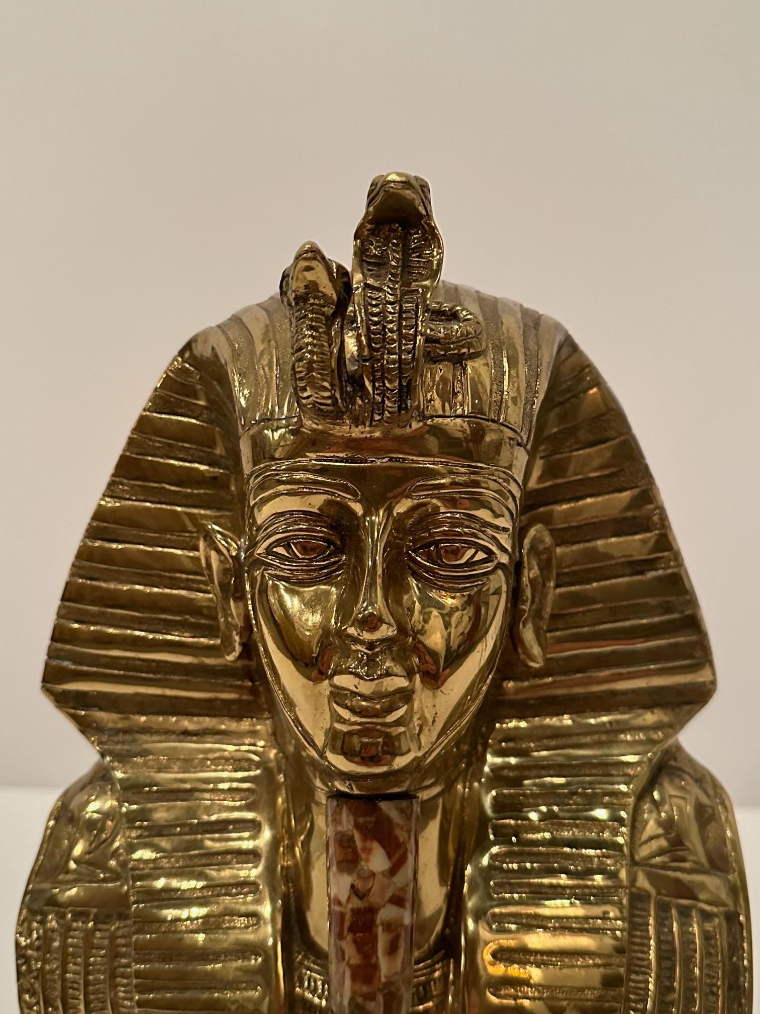 Dramatic large brass bust of King Tut having stone inlaid accent on the beard and resin base.