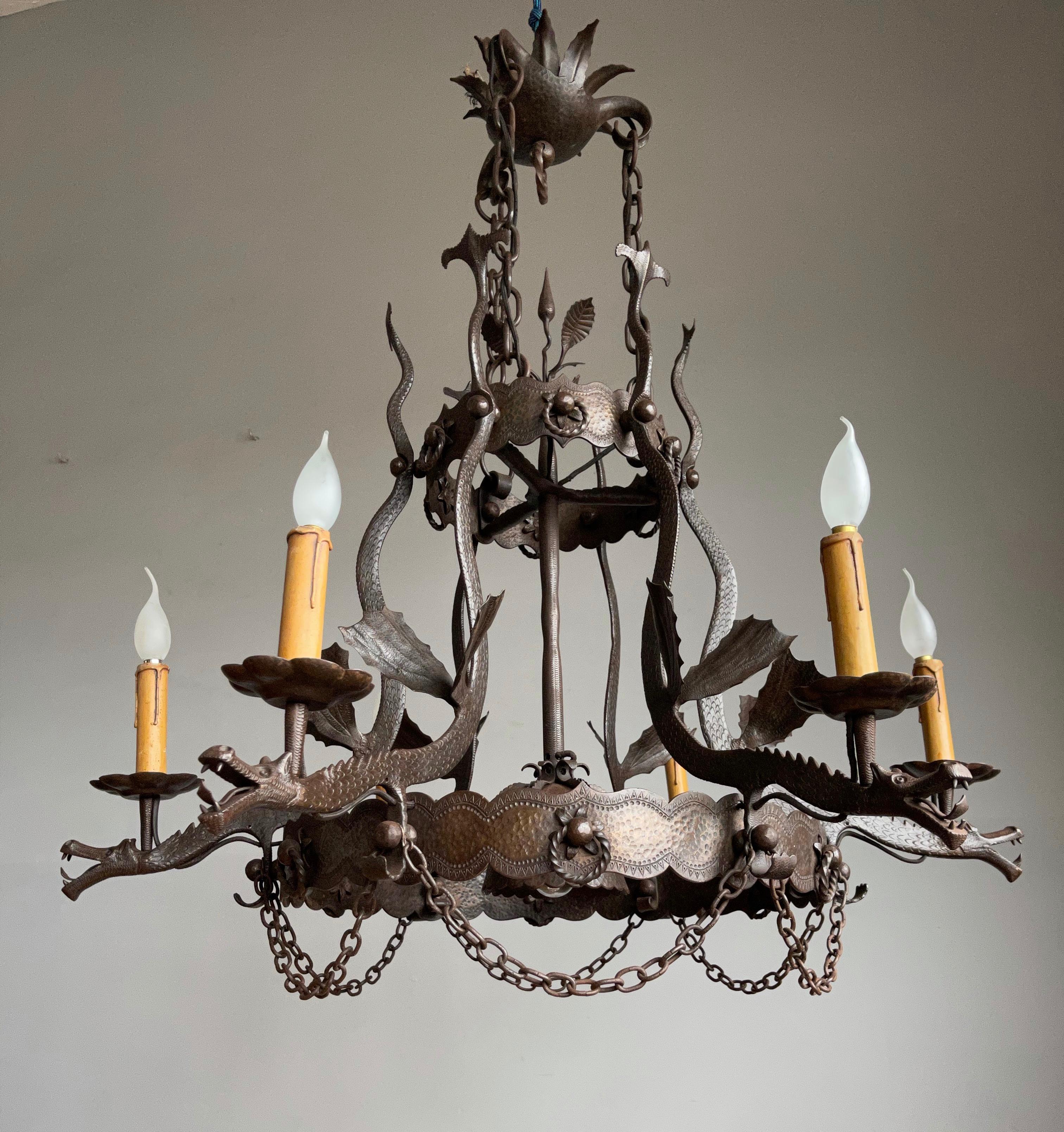 Amazing and skillfully made, Gothic art wrought iron pendant.

This artistically designed and outstandingly executed wrought iron dragon chandelier is in excellent condition and it comes with stunning and mint dragon sculptures. In fact, all six