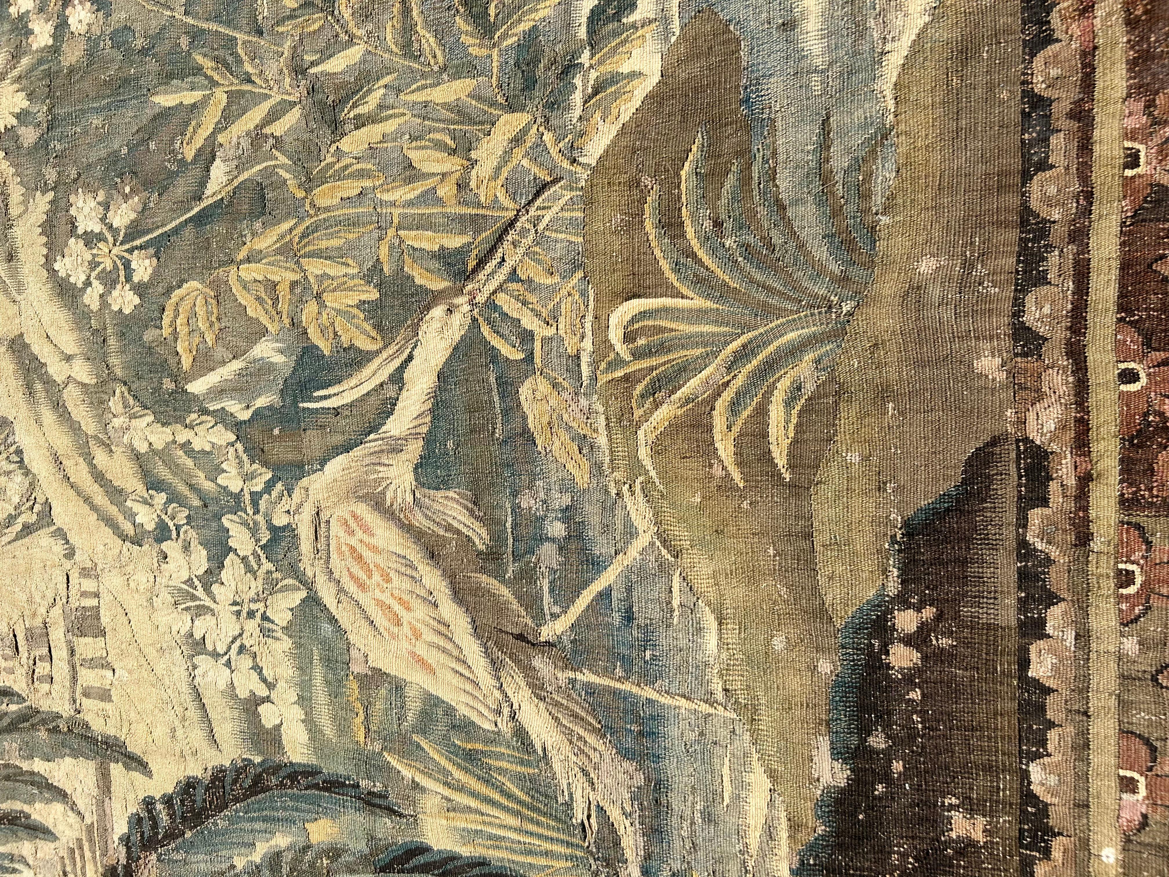 A Massive French 18th Century Aubusson Wool Tapestry with a picturesque scene with Antico Temples in a Palm Tree Landscape. Exotic Birds rest surrounded by water and lush fauna and foliage. In the background, there is a Chinese style pavilion and a