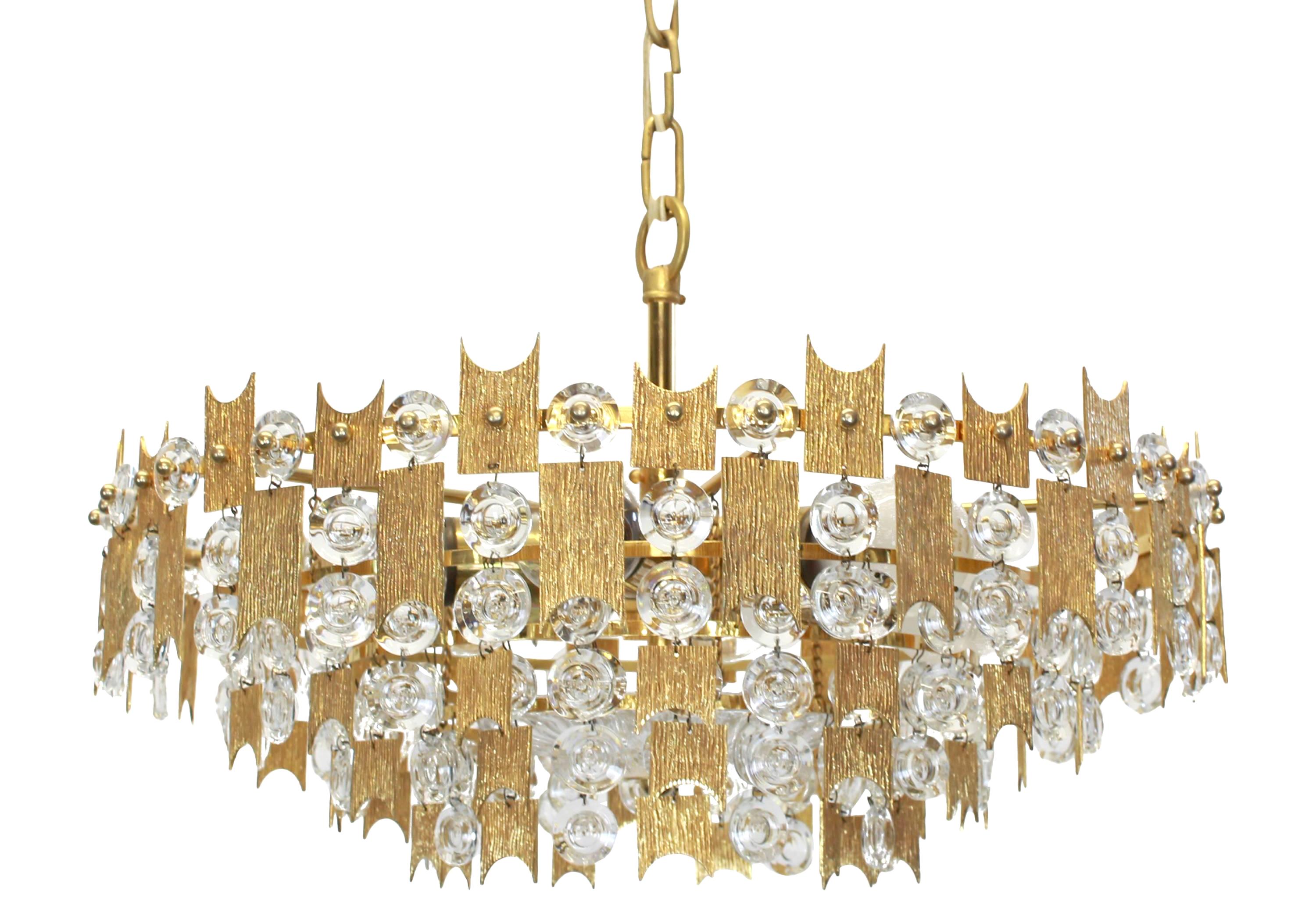 1 of 2  stunning chandeliers by Palwa (Palme and Walter), Germany, manufactured in the 1960s. Each chandelier is composed of jewel-like glass pieces and brass plates with a Brutalist relief.

Sockets: It needs six x E27 standard bulbs to illuminate,