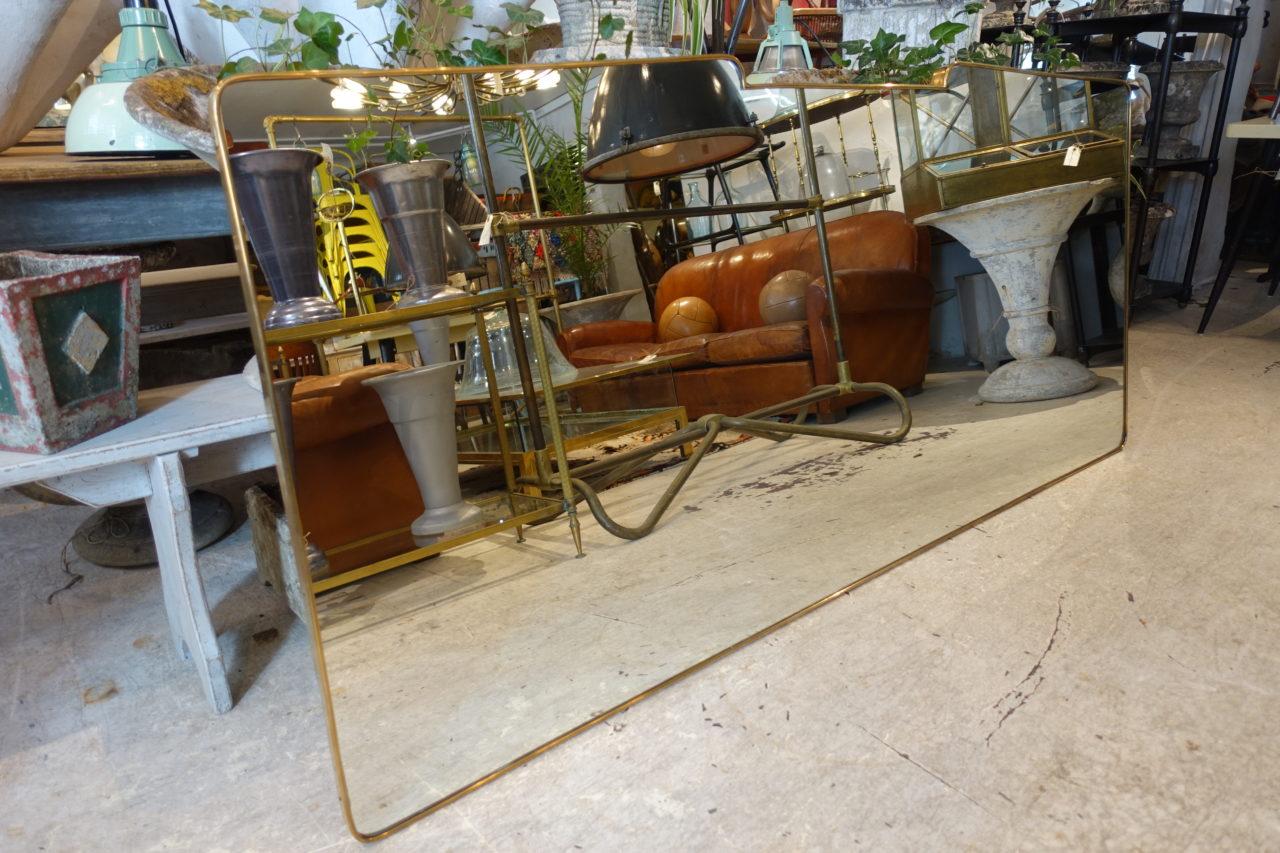 Stunning and gigantic vintage Italian brass framed mirror, from the 1950s. Original glass and gorgeous profile. Can be attributed style wise to the designer Giò Ponti. Wall hanging attachments on the back.