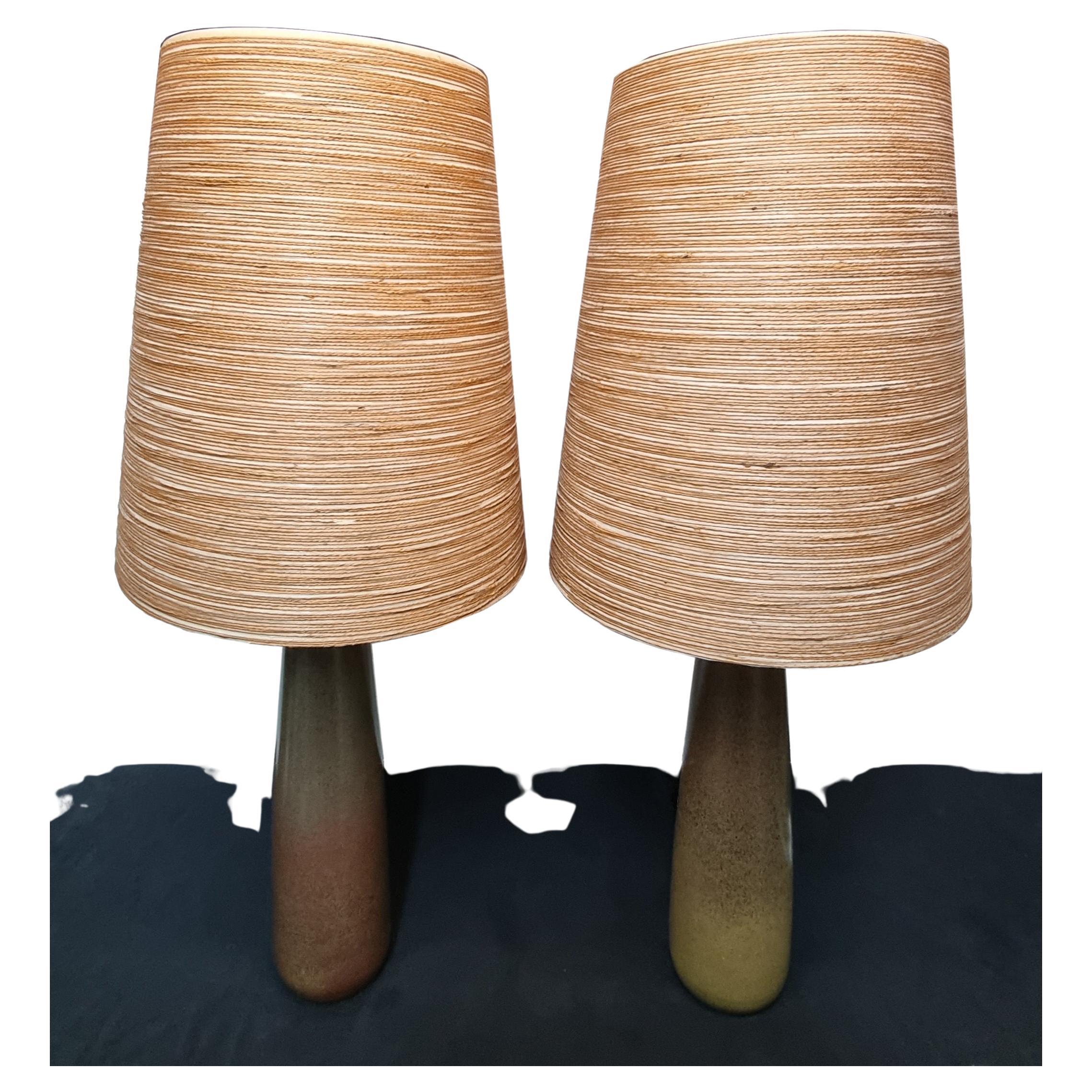 Impressive Large Pair of 1960s Ceramic Lamps by Lotte and Gunnar Bostlund.

Mid Century.

Mottled olive green colored bodies with a brown earth tones,
original fiberglass & jute shades & finials.

Lamps stand approximately 35 1/2