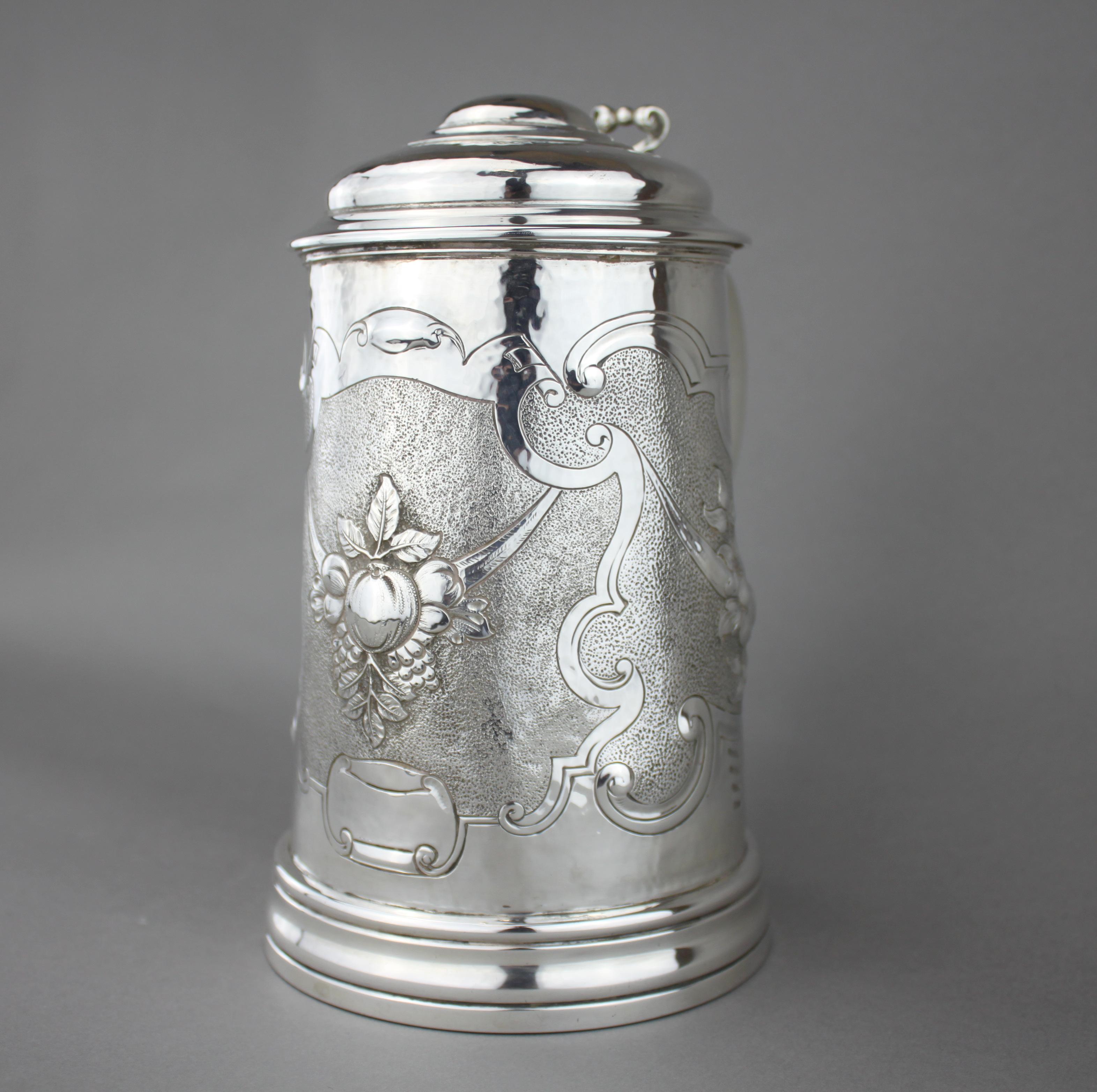 Antique large sterling silver tankard, with various floral scripture engravings
Maker: Mappin Brothers
Made in London, 1900
Fully hallmarked. 

Dimensions:
Length 19.5 cm
Diameter 13.5 cm
Height 22.5 cm
Weight: 1082 grams.

Condition: