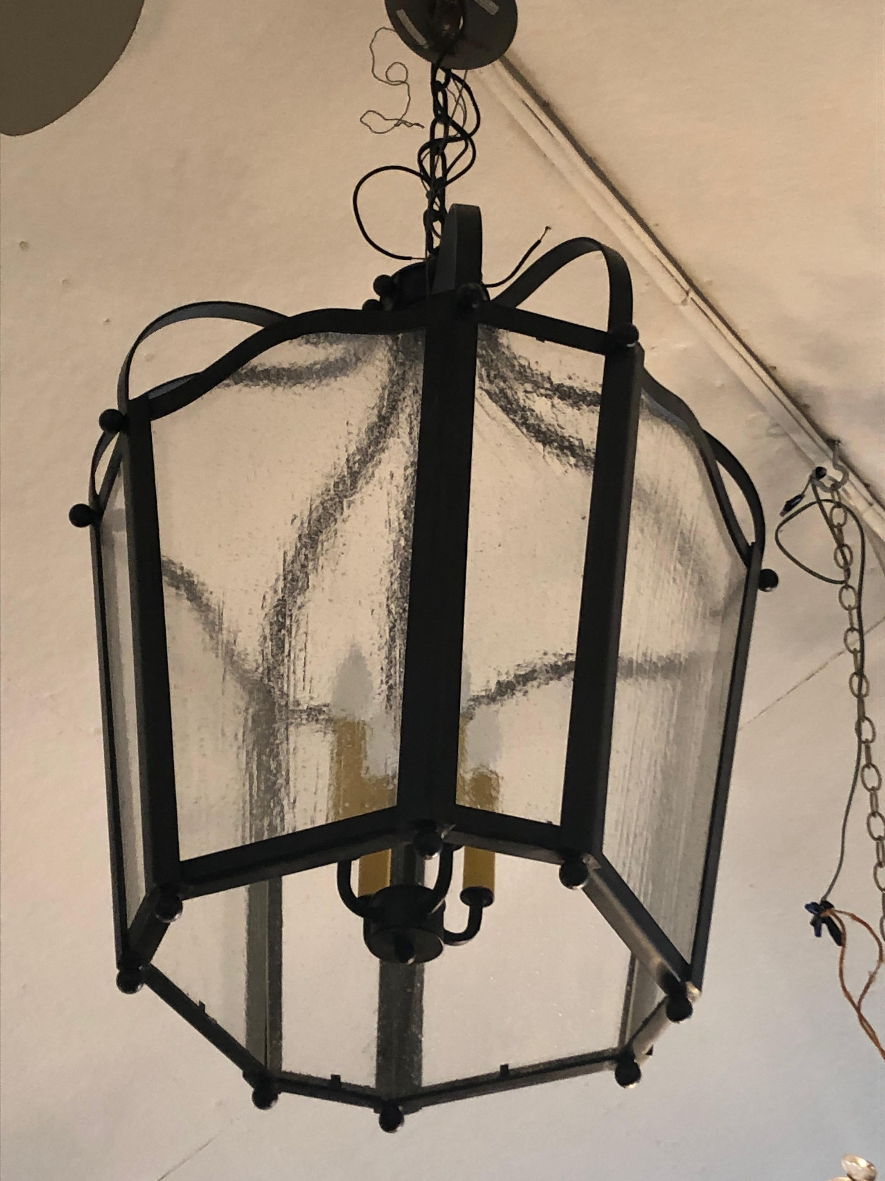 Very large lantern having slate dark grey iron frame with ball finials top and bottom, and wonderful seeded vintage glass. One just like it featured in Architectural Digest.  See photo. 4 bulbs inside.

