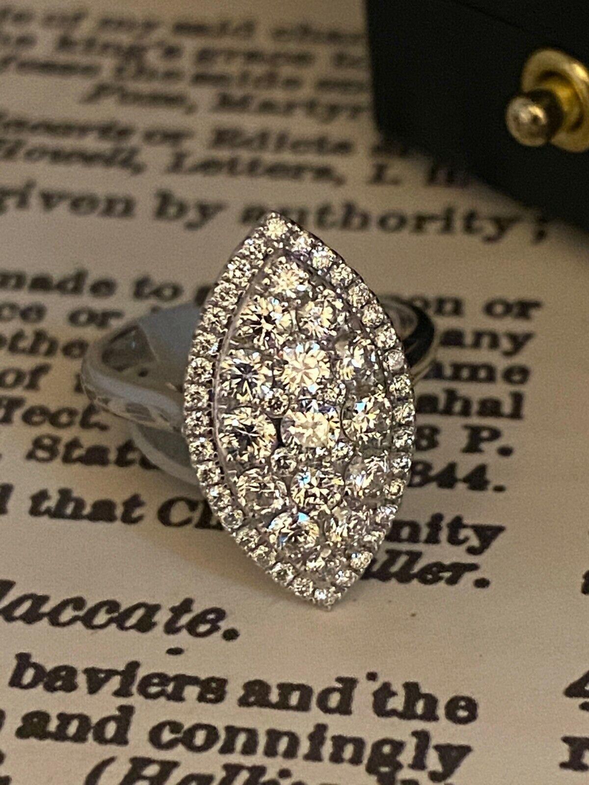 Of an eye-catching Marquise Shape, 
this Cocktail Ring is pave-set with finest quality Round Brilliant Cut Diamonds 
of rather impressive size, 
totaling 1.85ct approx. 
Colour: F, Clarity: VVS 

Within a diamond set surround 

Mounted in