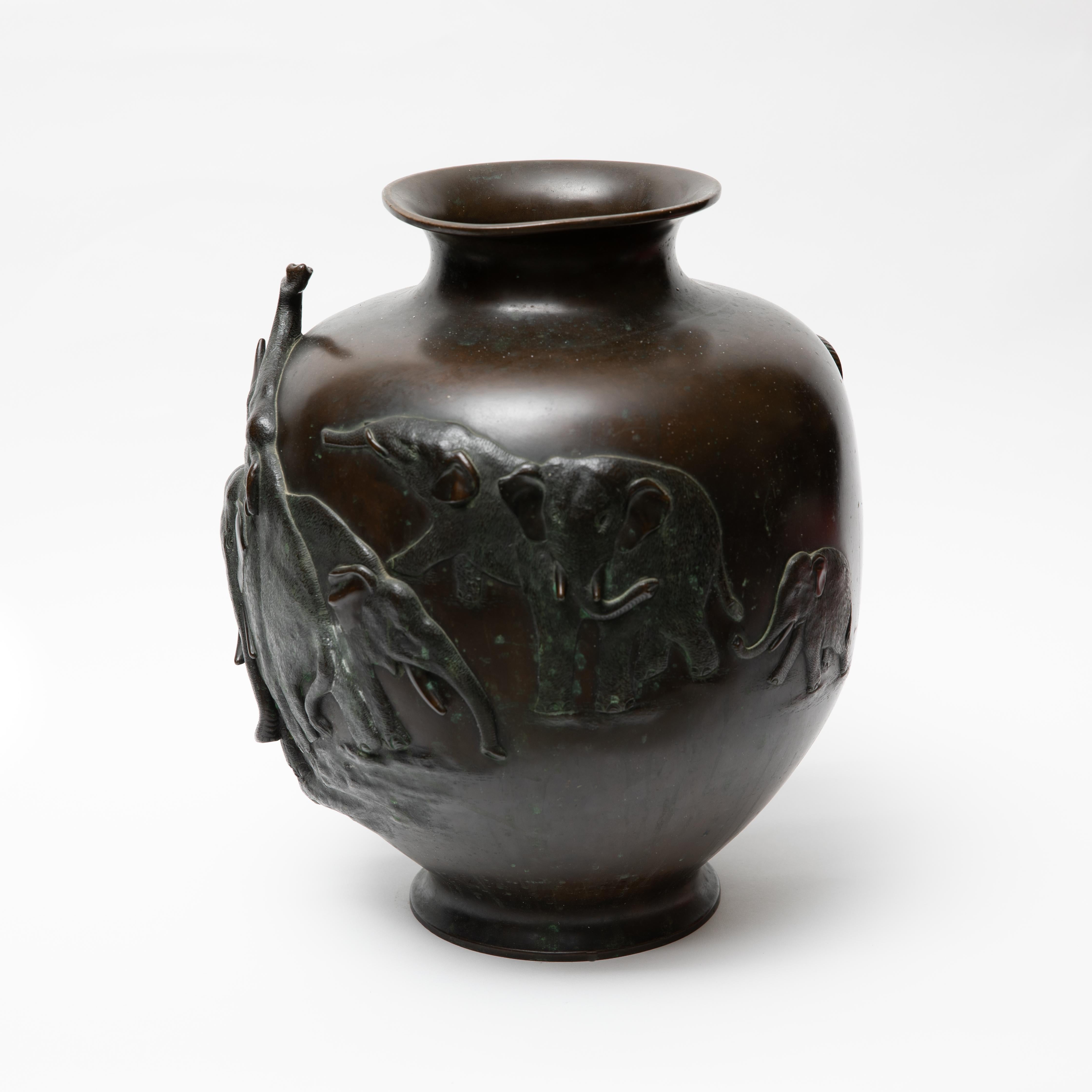 Meiji Japanese bronze baluster jar with elephant motif. Cast in relief with continuous frieze of elephants, the base with six-character maker marks. Measures: Approximate height 15 1/4