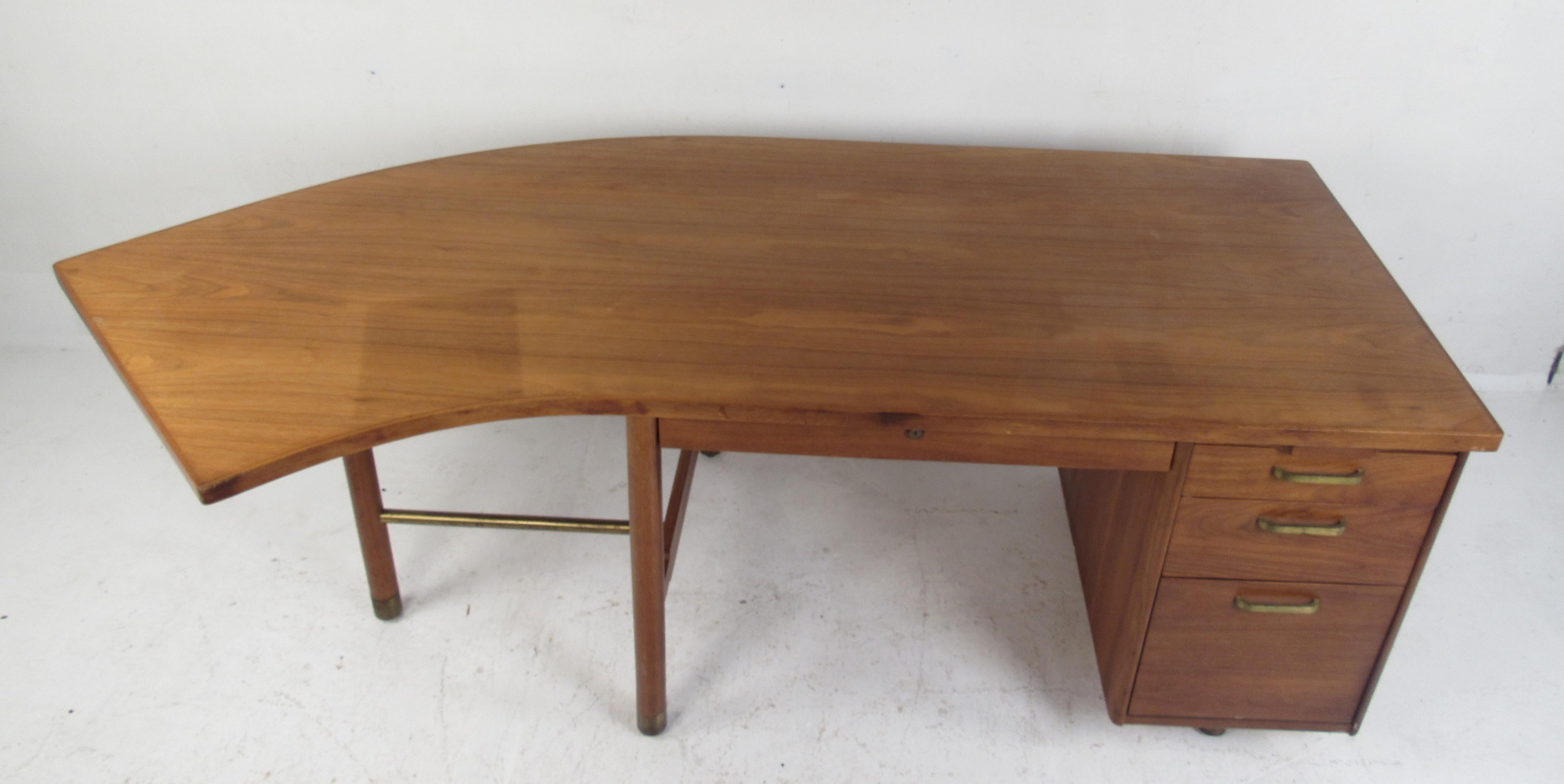 This stunning vintage modern desk features an unusual curved top offering plenty of work space. Quality construction with a finished back and charming walnut wood grain. This wonderful mid-century case piece has ample storage space within its four