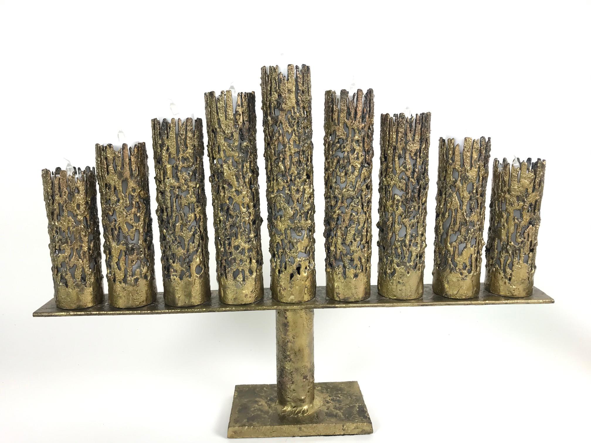 Magnificent Mid-Century Modern one-of-a-kind Brutalist style brass Studio Hanukah Menorah makes a dramatic statement. Artist mark on the bottom: JG, measures 12 inches H x 22.25 inches W x 2.5 inches D. Sculptural in essence, made of solid brass,