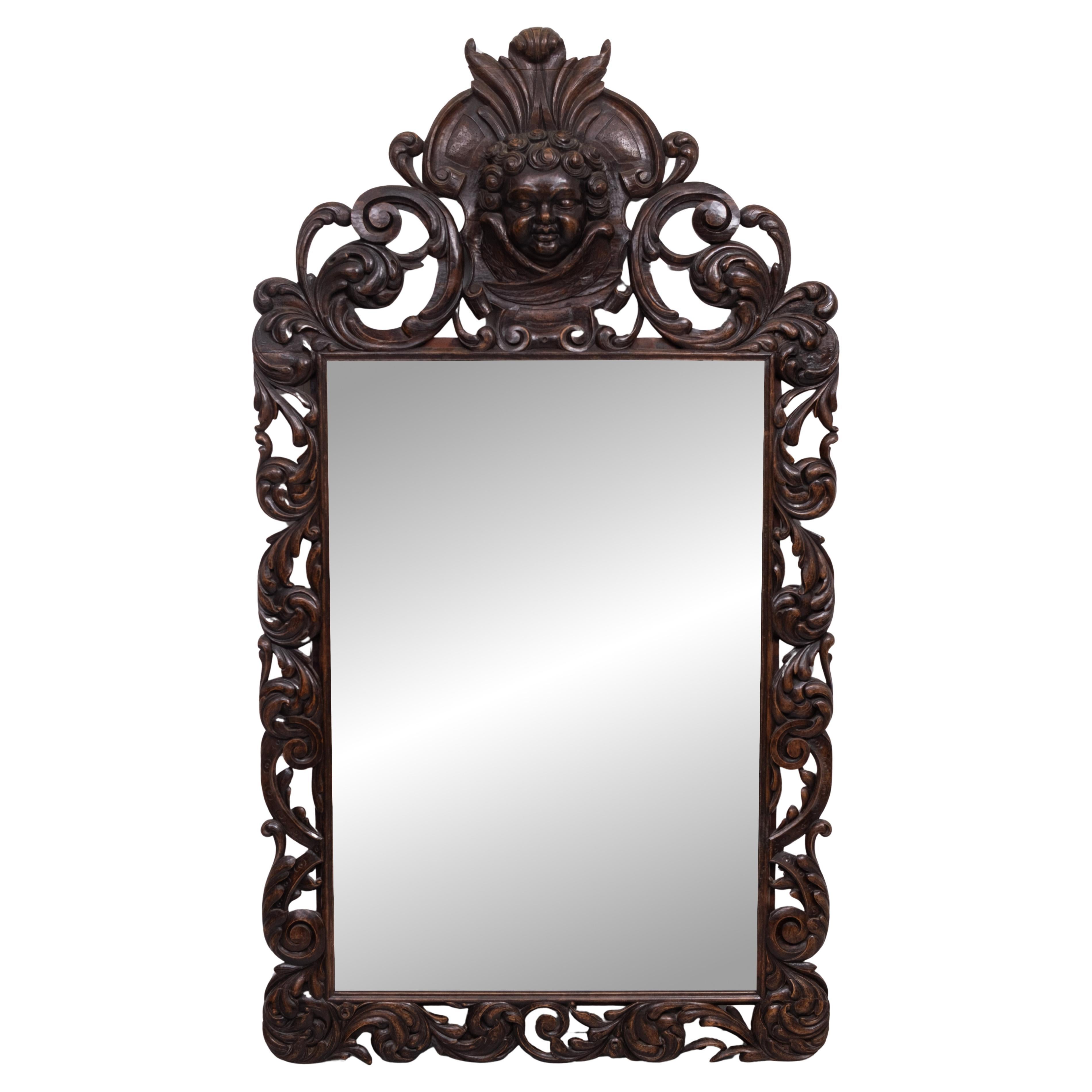 Antique monumental wall Mirror . hand carved Oak frame .  
comes with a  Cherubs  head .and his wings , beathiful carved . 
no symmetry in the carving between the left or Right side of the Mirror . 
A real 18 century Mirror . Very impressive mirror