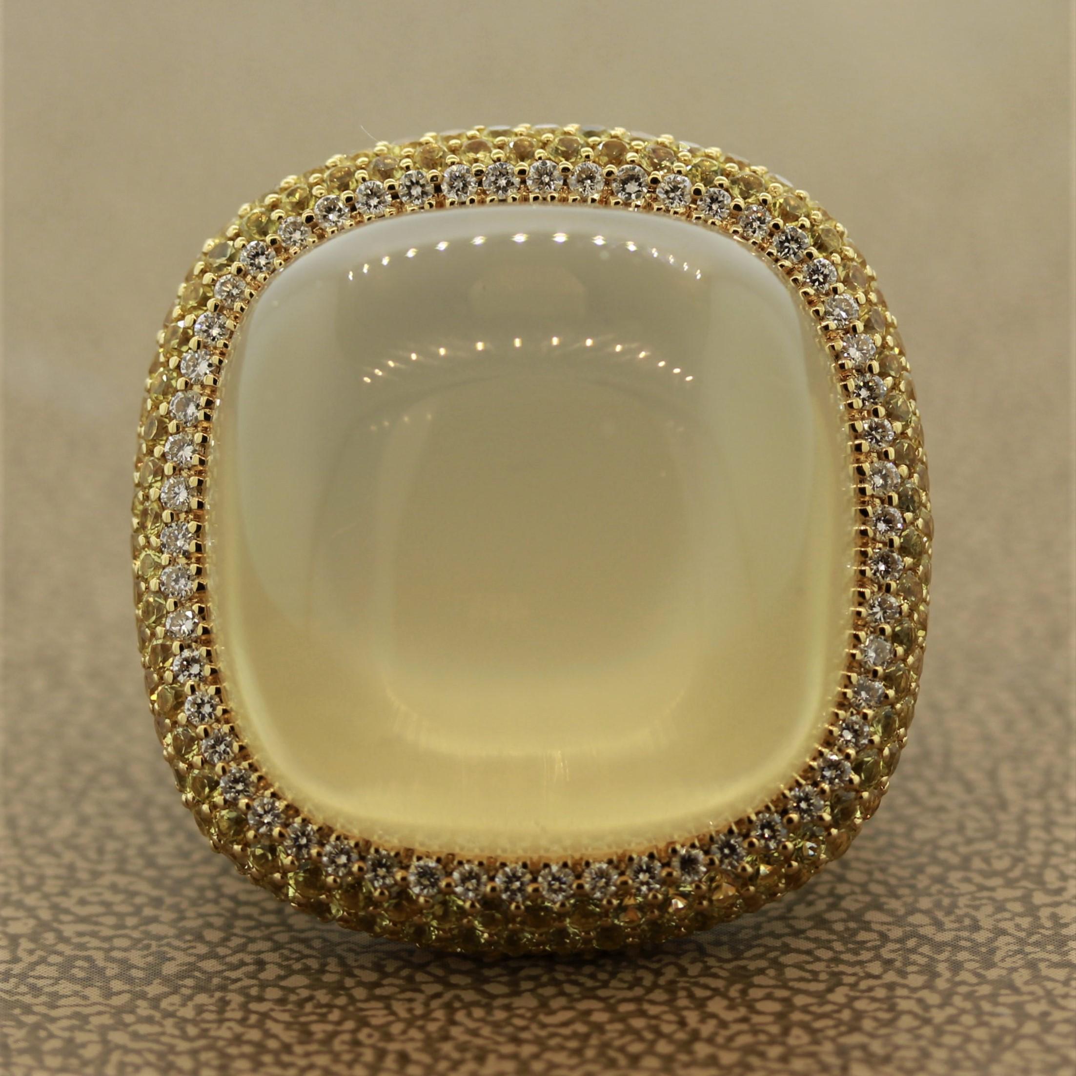 A bold cocktail ring featuring a large gem quality moonstone weighing 58.80 carats. The stone shows excellent adularescence which is light rolling over the surface of the gem, a special natural phenomenon of fine moonstones. It is accented by 6.48