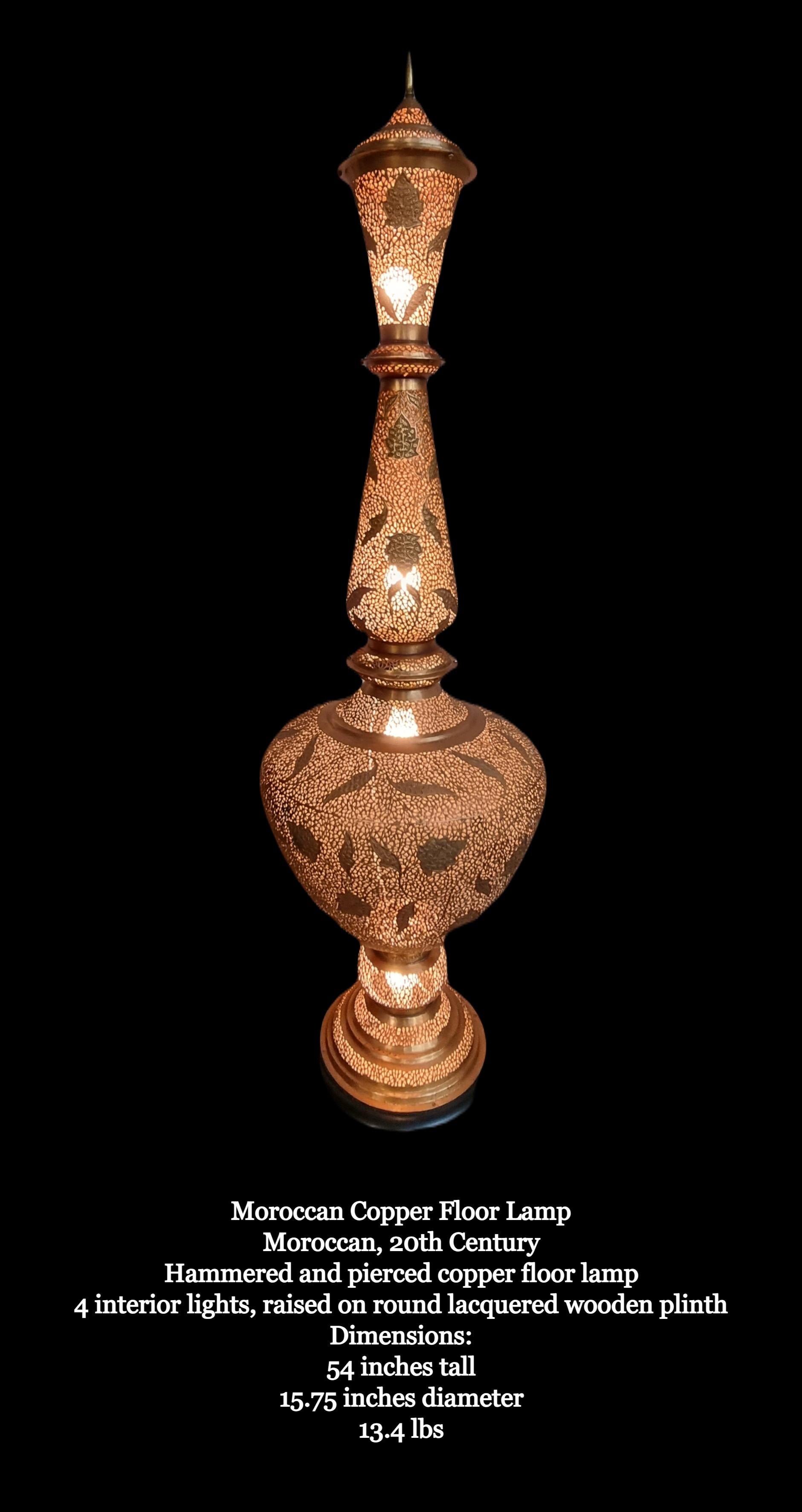 Impressive Moroccan Hand Hammered & Pierced Copper/Alloy Floor Lamp

Moroccan, 20th Century.

Hammered and pierced copper/alloy floor lamp
4 interior lights, raised on round lacquered wooden plinth.
Due to size shipping quote will be quoted per