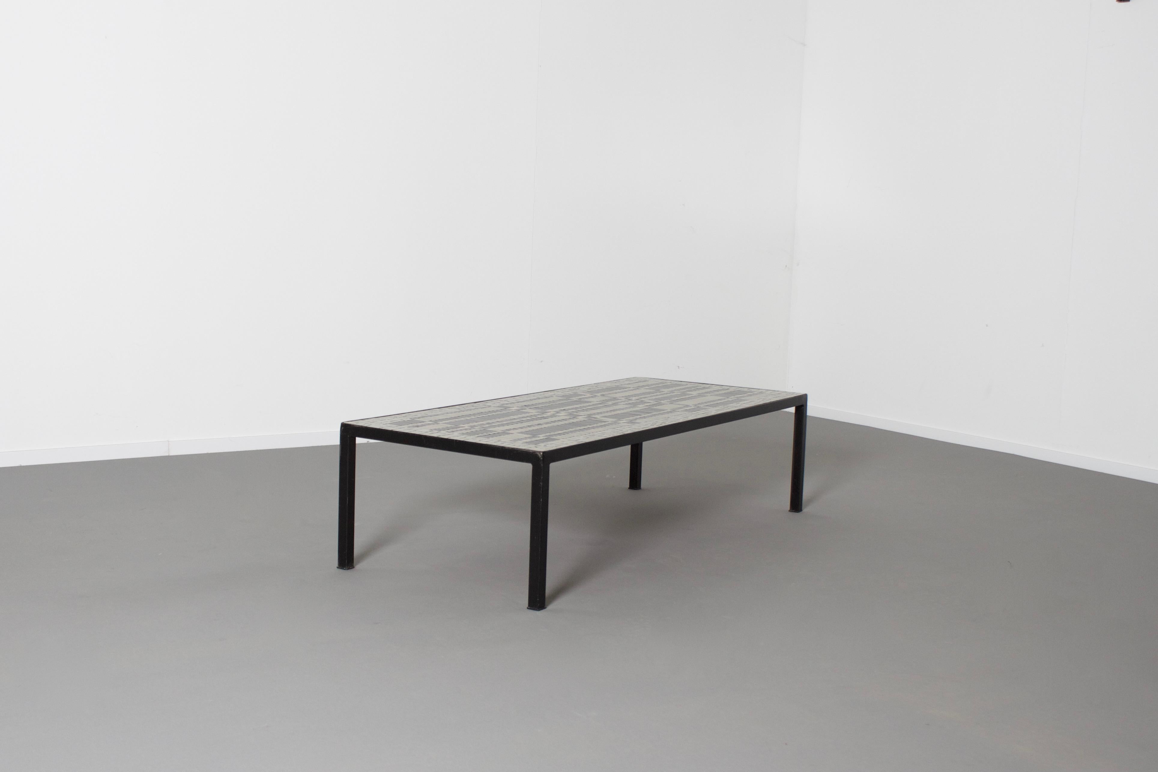 Impressive coffee table by Berthold Müller in good condition. 

Manufactured by Mosaikwerkstatt Berthold Müller-Oerlinghaus. 

The mosaic top of these tables is composed of tiles in black and white. 

The rim of the top is made of black metal. 

The