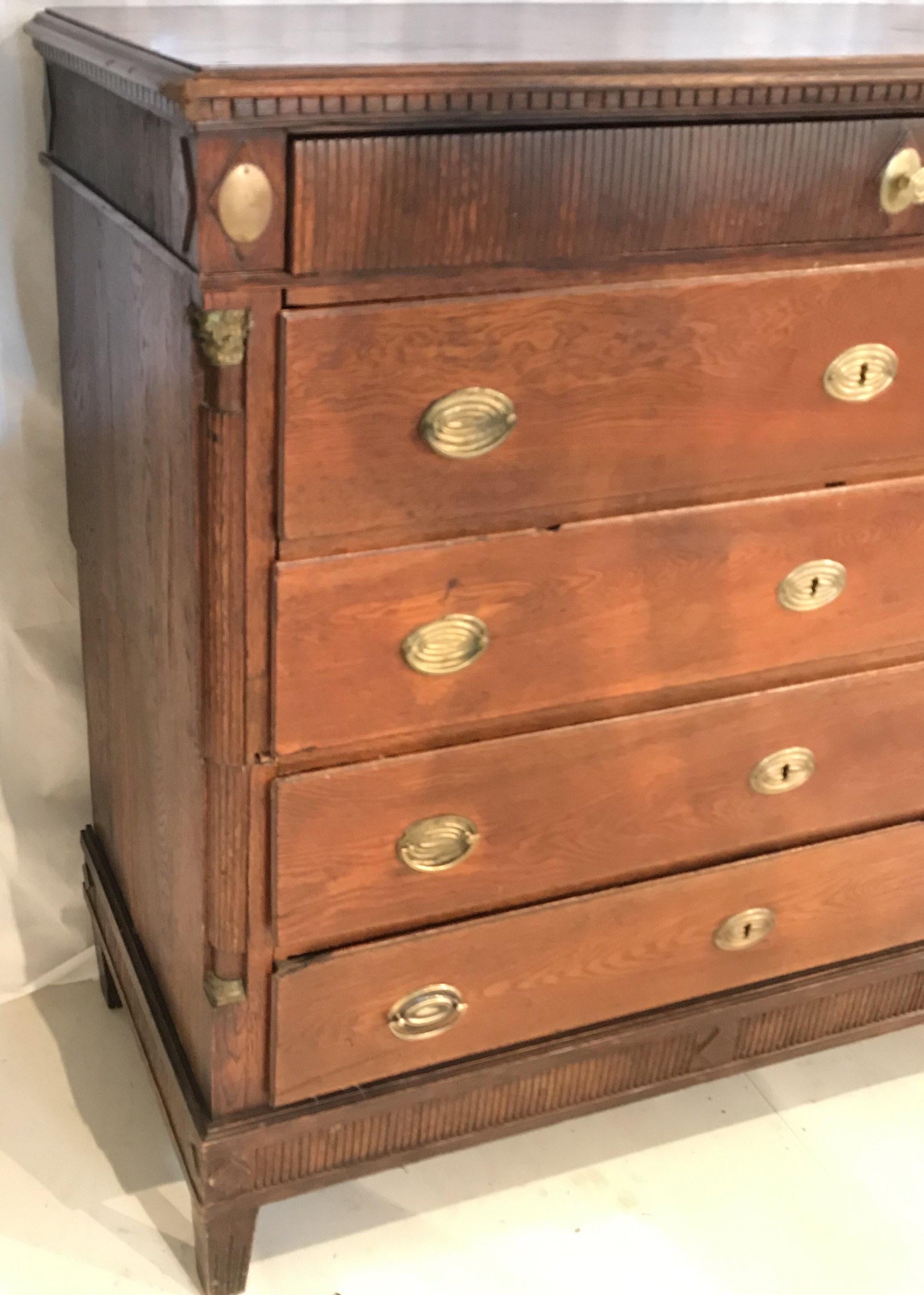 A handsome Campaign style oak commode having beautiful detailing, reeded top drawer and brass ornamented columns in a Classic design. The chest has 4 roomy drawers, and is in two parts so easily moved.
#1990.
   