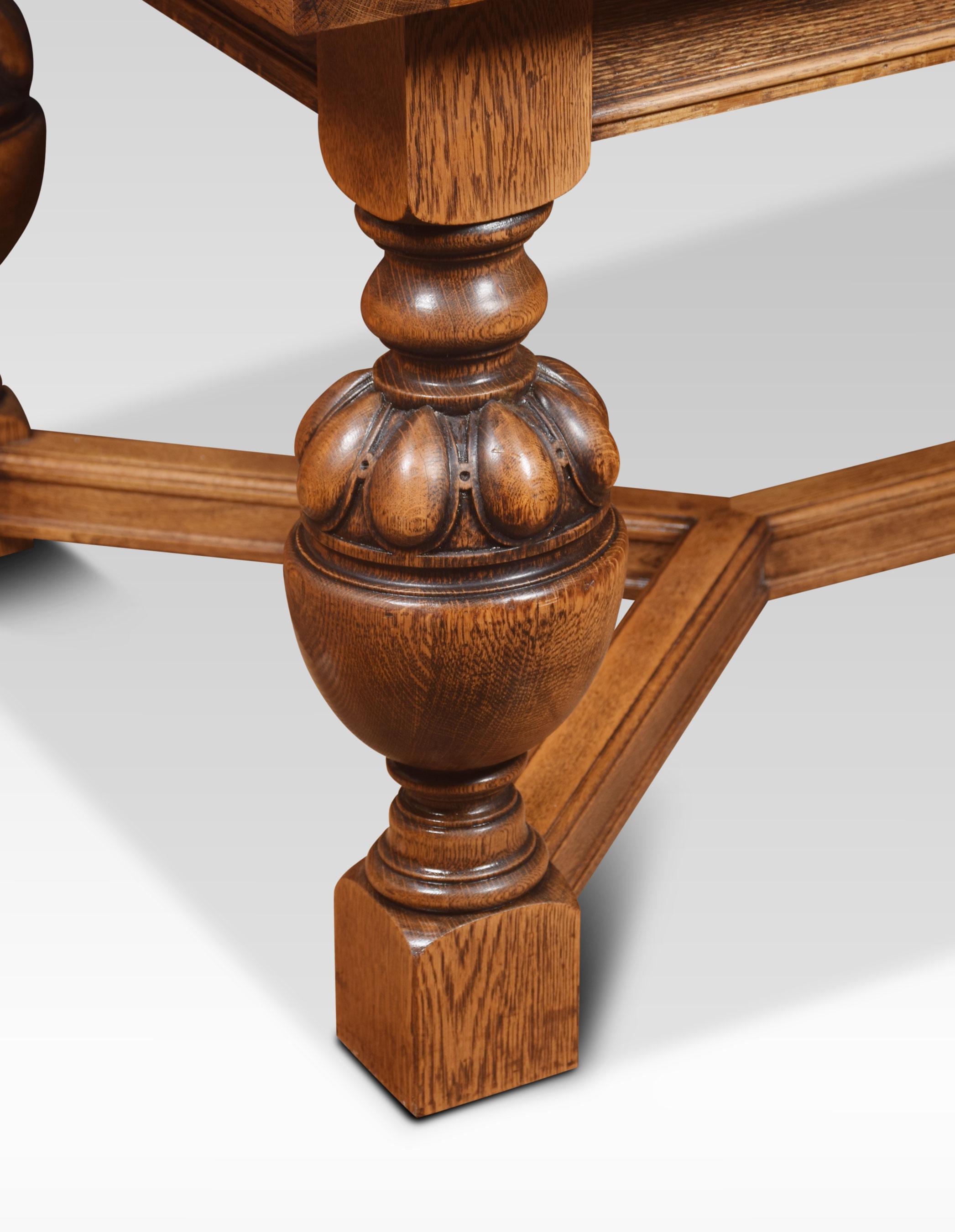 Very large impressive oak draw-leaf table of generous proportions. The thick plank top having pull-out leaves to each end. To the moulded frieze above the gadrooned bulbous cup and cover legs leading down to block feet united by
