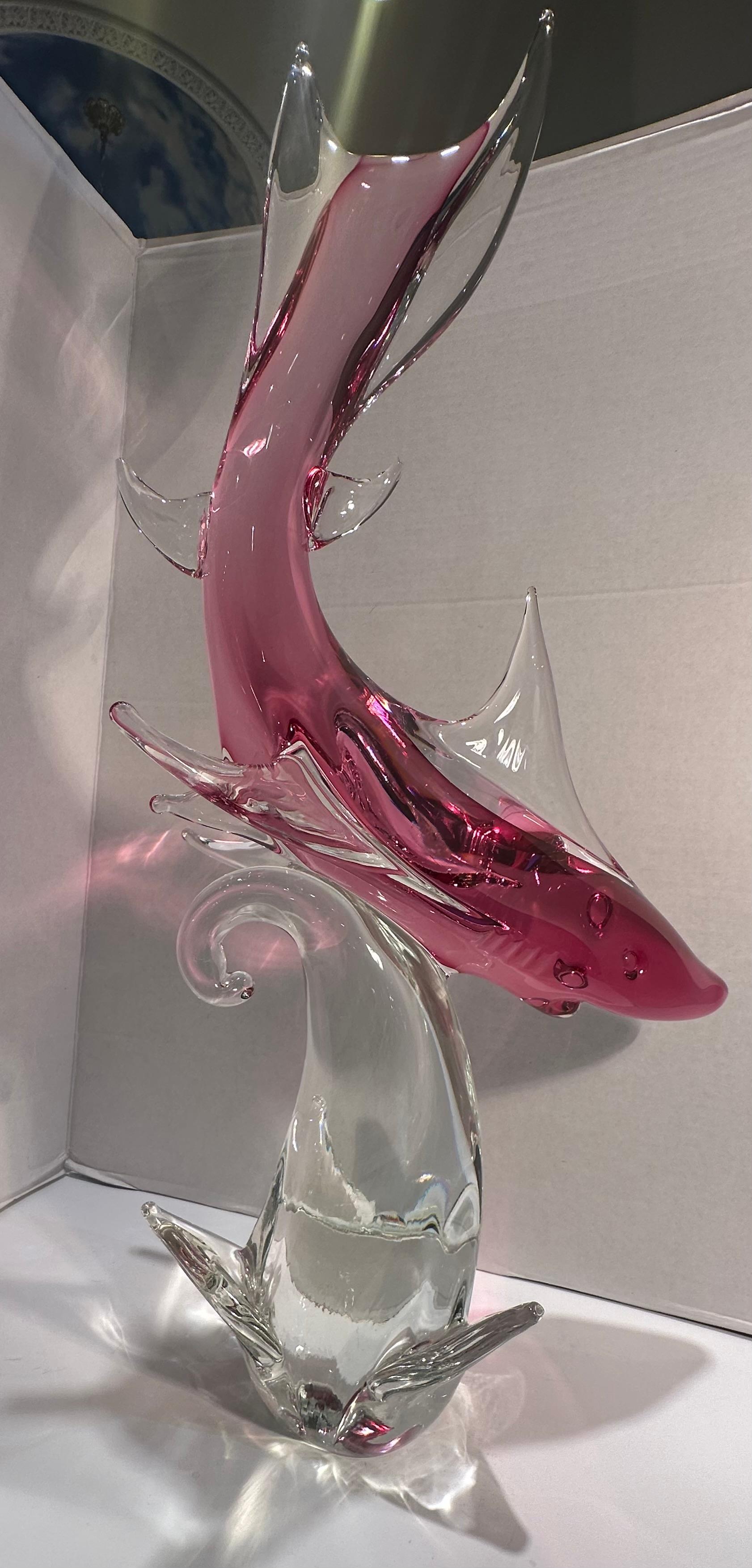 Very impressive, hand made and mouth blown in Italy, Murano art glass figure or sculpture of a shark in a very vibrant hot pink color, with clear and pink fins, set on a free flowing clear glass wave plinth. This is a very large and stately art