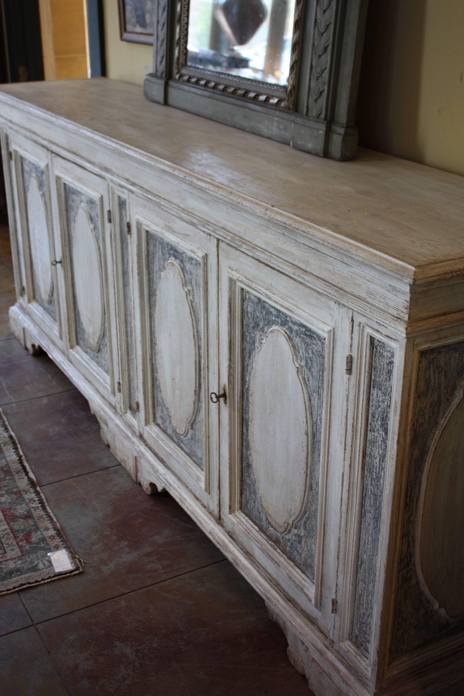 Late 19th century enfilade or sideboard in a simple design and good scale, hand dry scraped to show traces of chalky white and pale blue paint.
 